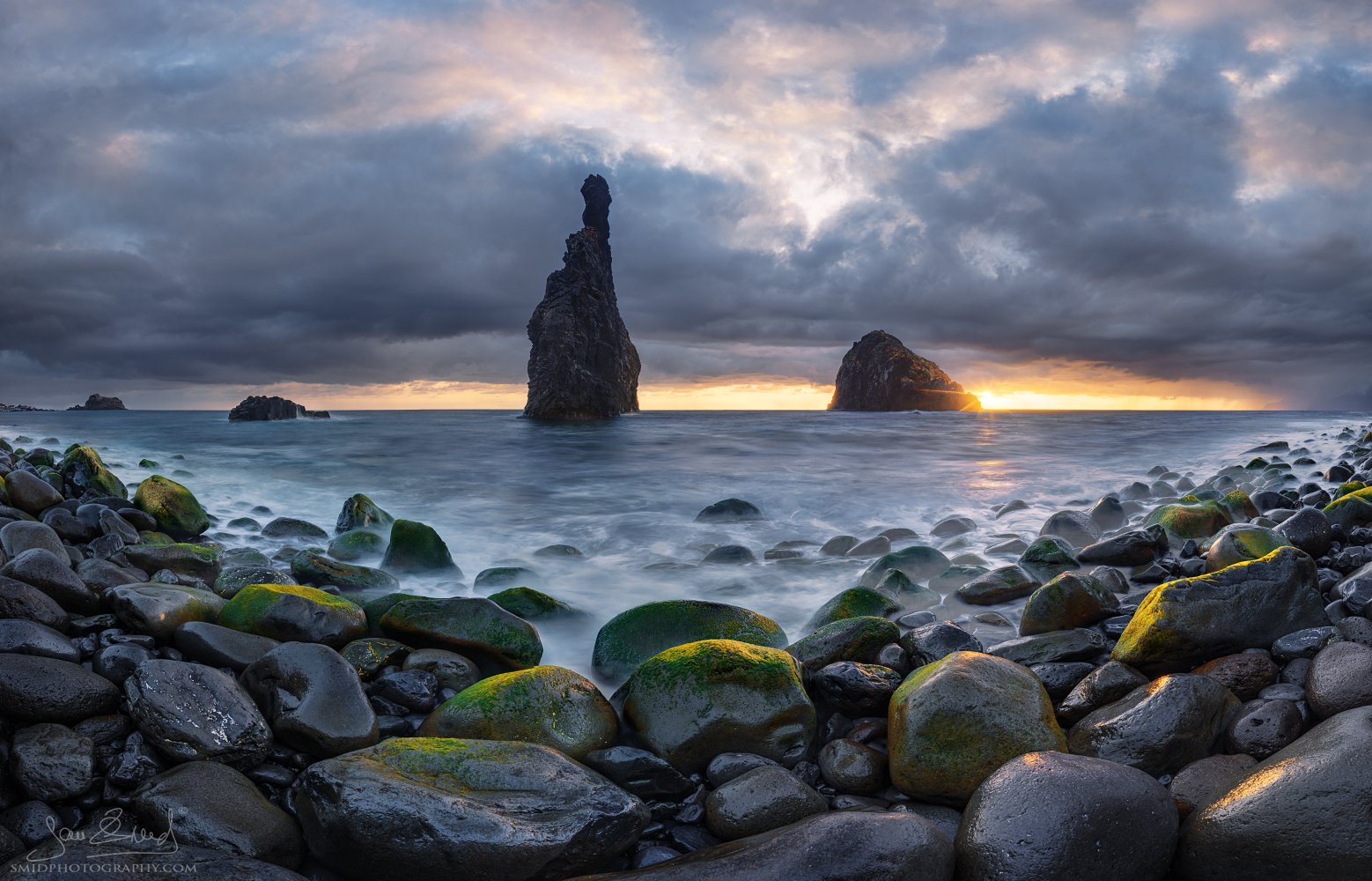 Wide panoramic seascape photograph "For a Moment" capturing the majestic sea stacks of Ribeira da Janela, Madeira, during a golden sunrise. Shot by Jan Smid, Master QEP, during a 2024 photography expedition.
