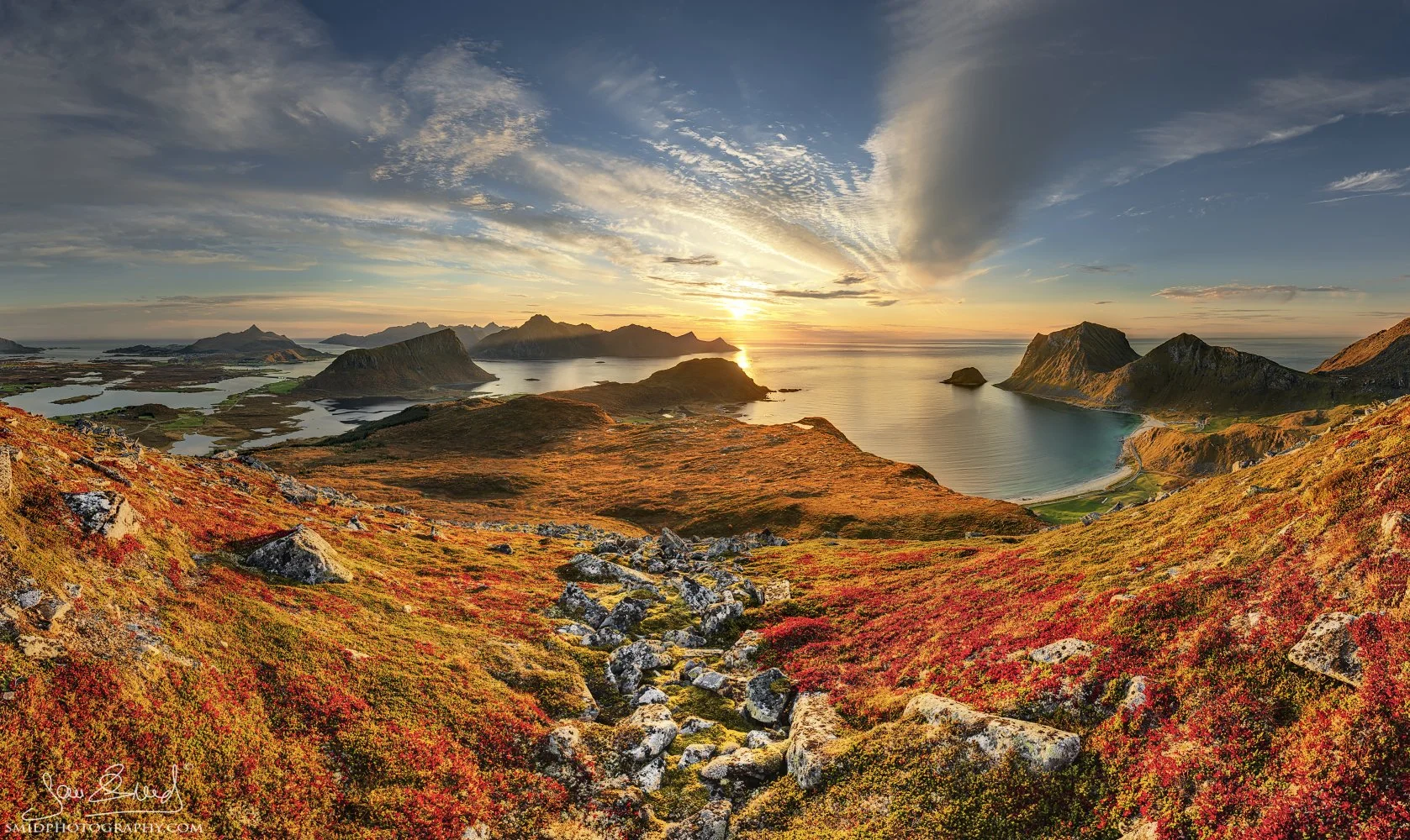 Panoramic landscape photograph "Stone Path to the Sea" capturing vibrant autumn colors and rocky coastal textures under the golden sunset light in Lofoten. Captured by Jan Smid, Master QEP, in 2021.