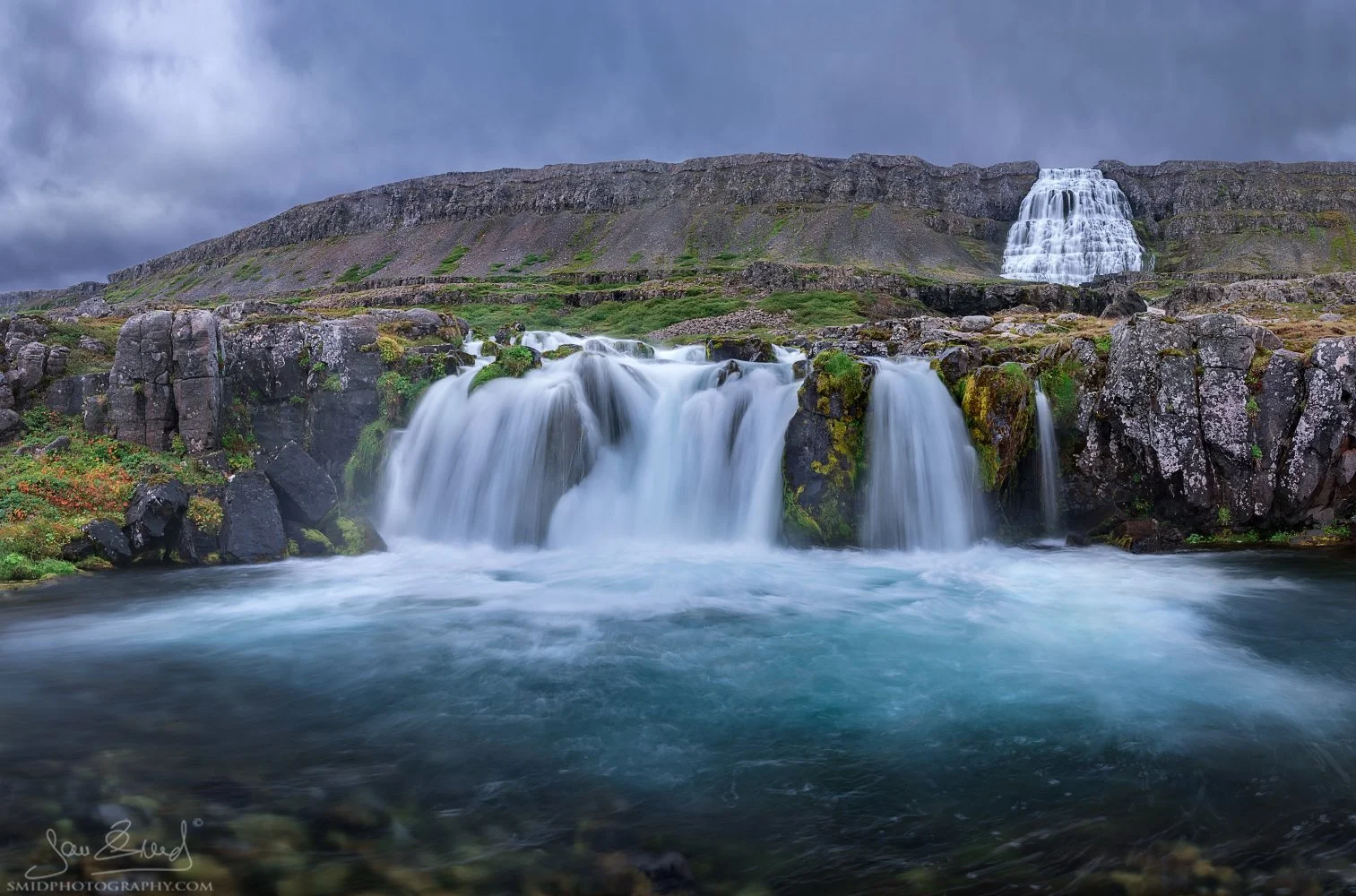 Large-scale waterfall panorama titled "Icelandic Shower" at Dynjandi, Westfjords, Iceland. Dramatic cascading water over bridal-veil rock formations. Captured by Jan Smid, Master QEP, during a 2015 photo expedition. High-end fine art.