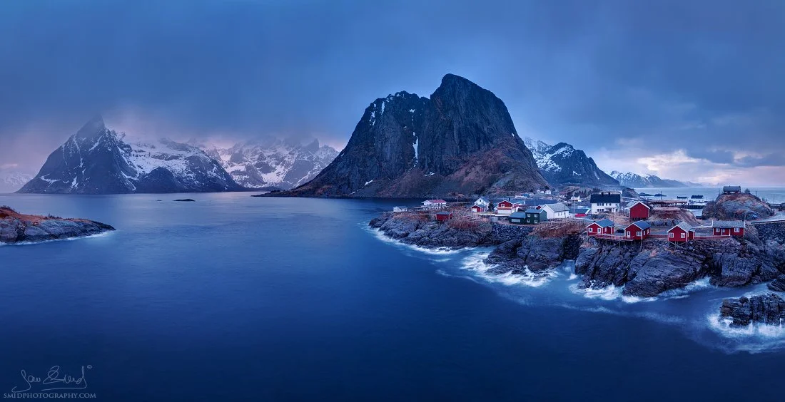 Dramatic mountain ridge above Reine captured with ND filter — long-exposure panorama from a Lofoten photo tour.