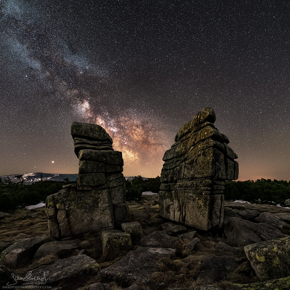Square panoramic night photography of the Milky Way above two frozen trees in the Giant Mountains, titled Twins, by Jan Smid, Master QEP. Winter 2020.