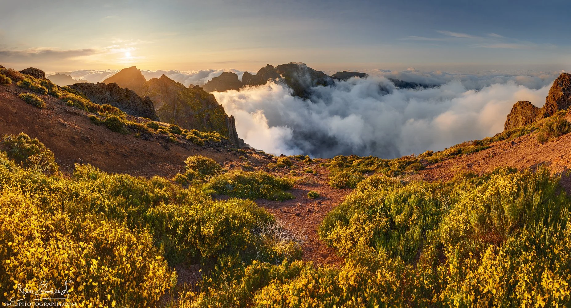 Panoramic landscape photograph "Wrapped in Cloudy Quilts" featuring a breathtaking cloud inversion at sunset from Pico do Arieiro, Madeira. Captured by Jan Smid, Master QEP, during a 2023 photography expedition.