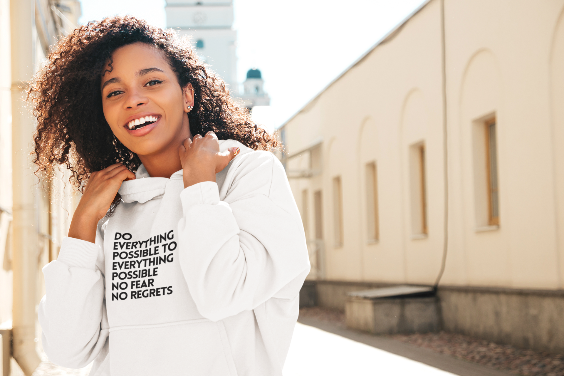 pullover-hoodie-mockup-of-a-smiling-woman-with-curly-hair-on-a-street-m25557-r-el2.png