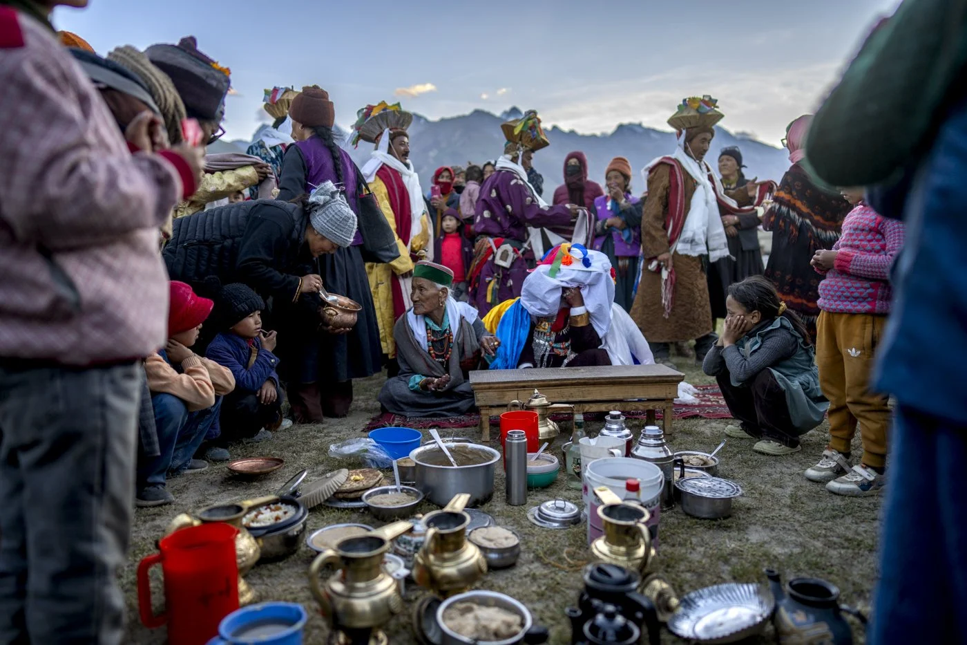 Hochzeitsgesellschaft mit Teekannen und Schalen im Freien, Zanskar