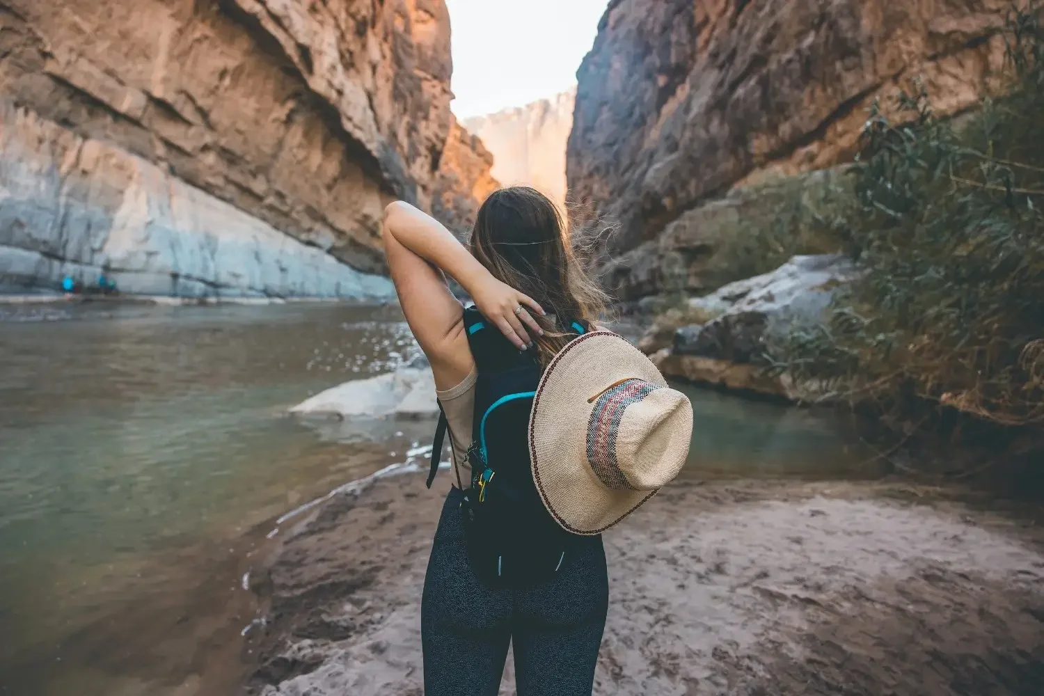 A female hiker takes a moment to admire Santa Elena Canyon and the Rio Grande at Big Bend National Park.