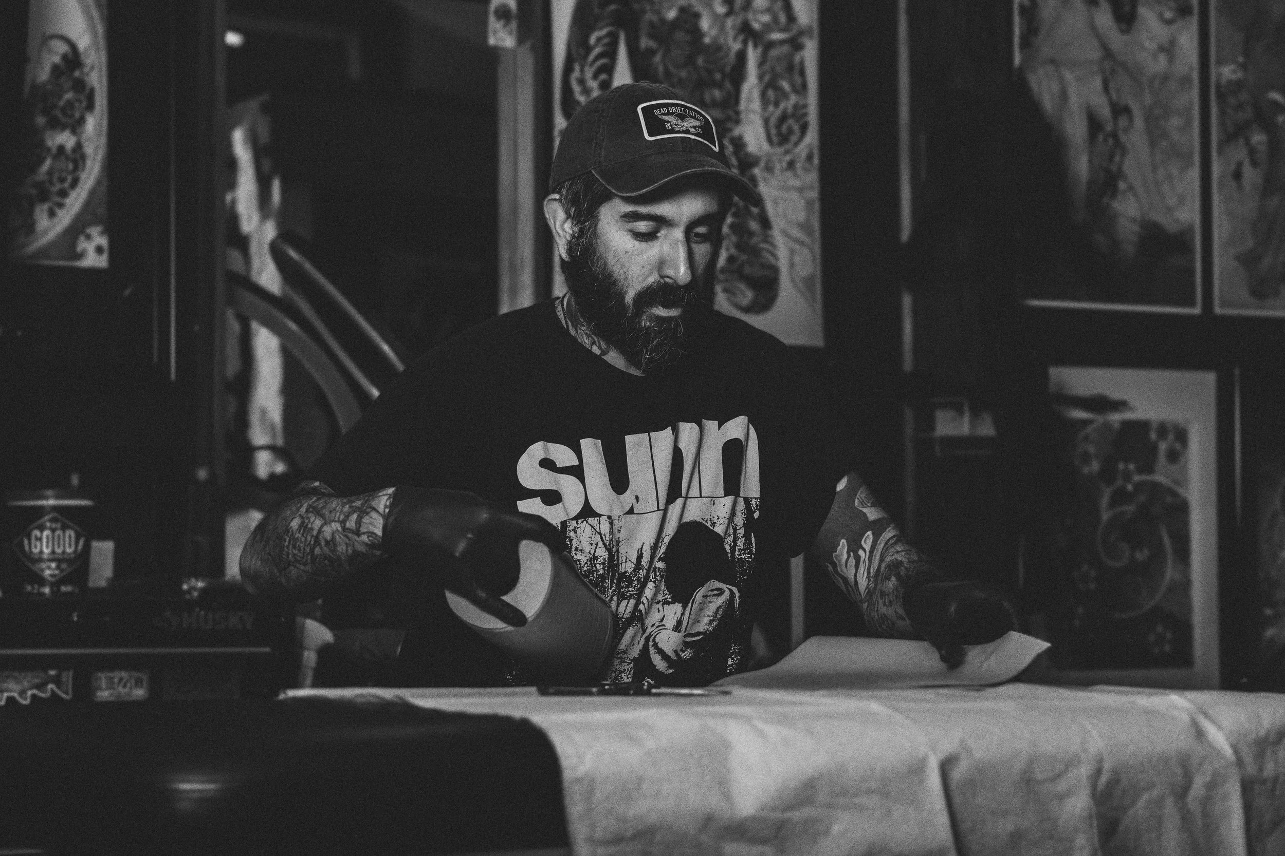 black and white photo-tattoo artist preparing for appointment-tattoo consultation