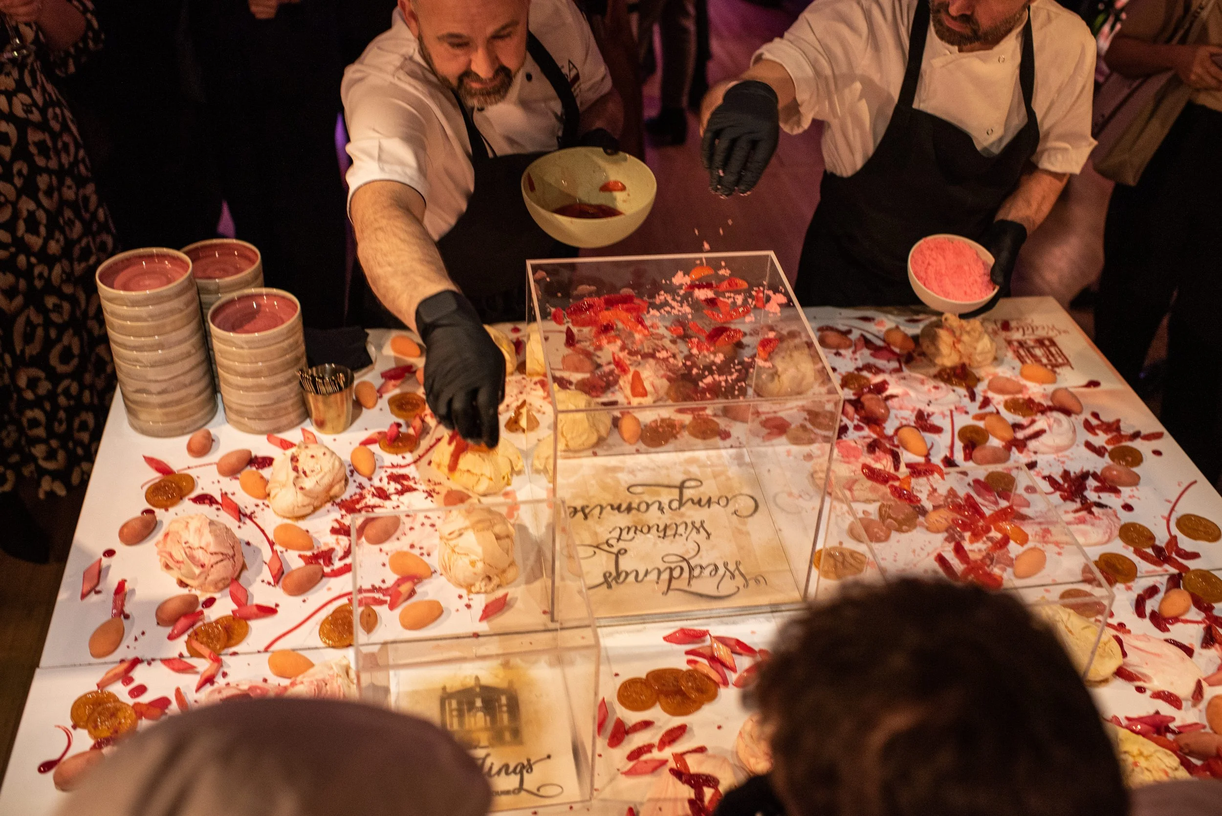 Wedding chef creating dessert on a table in front of guests