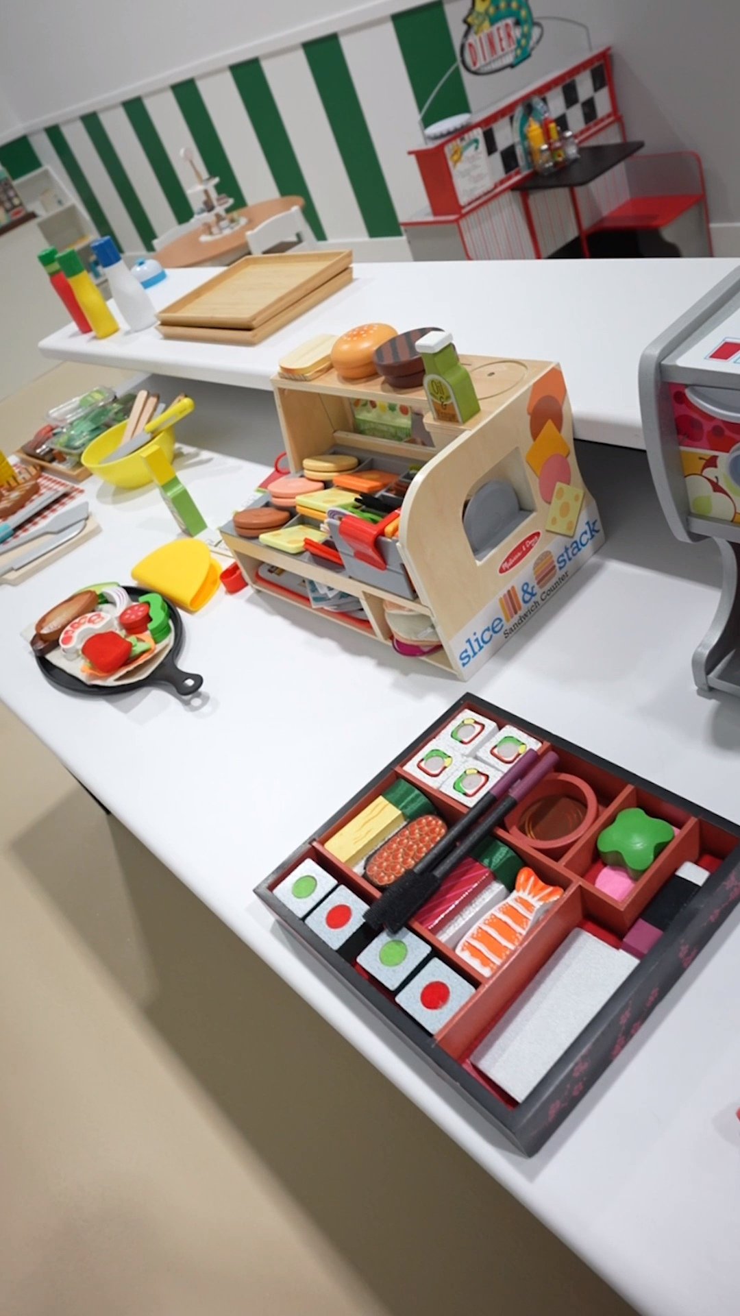 Toy kitchen play set with pretend food, utensils, and shelves for children