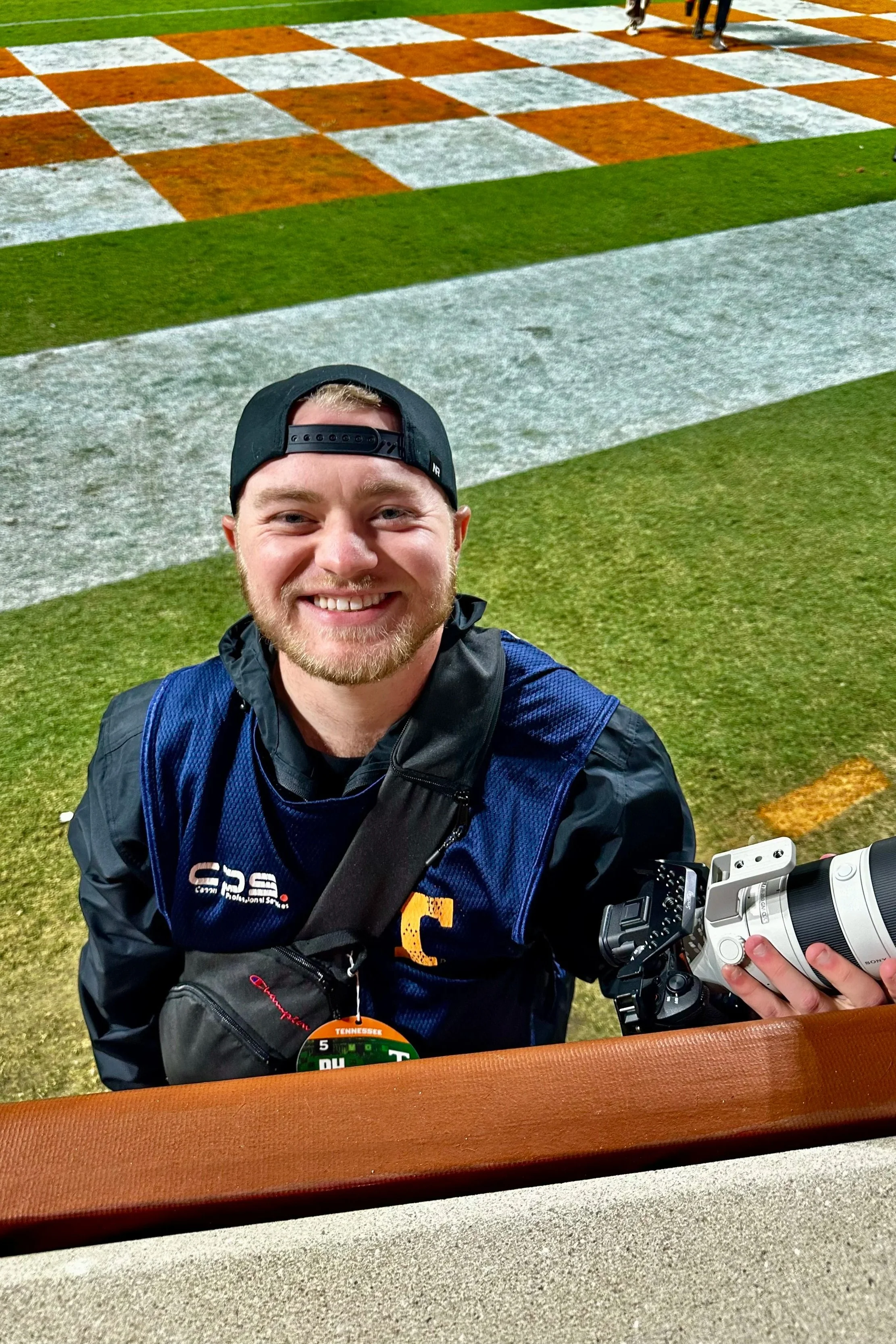 Man with camera on the field of Neyland Stadium