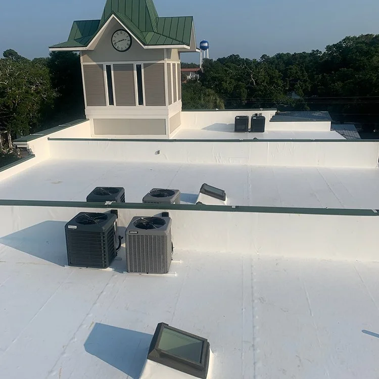 Rooftop with air conditioning units and a clock tower