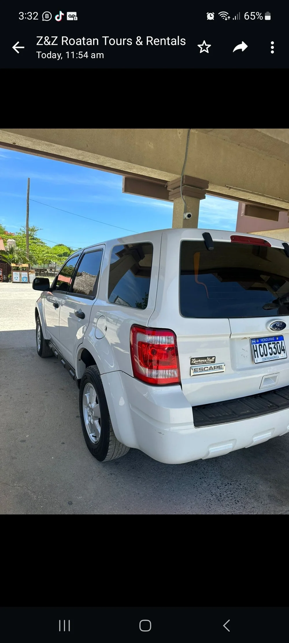 A white SUV available for rental on Roatan