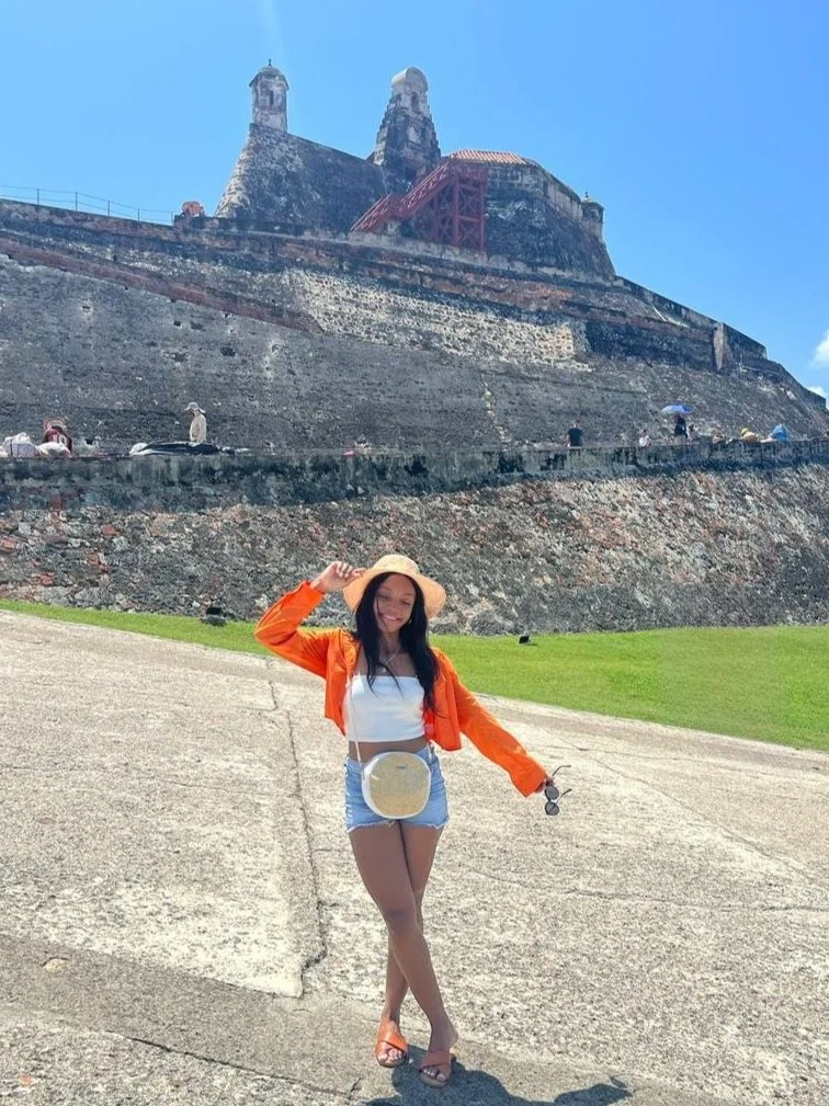 Roxana standing in front of a historic Roatan fortress