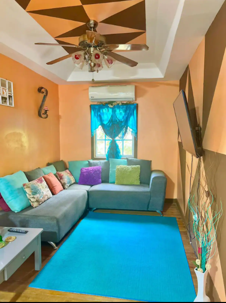 A bright, comfortable vacation rental living room on Roatan