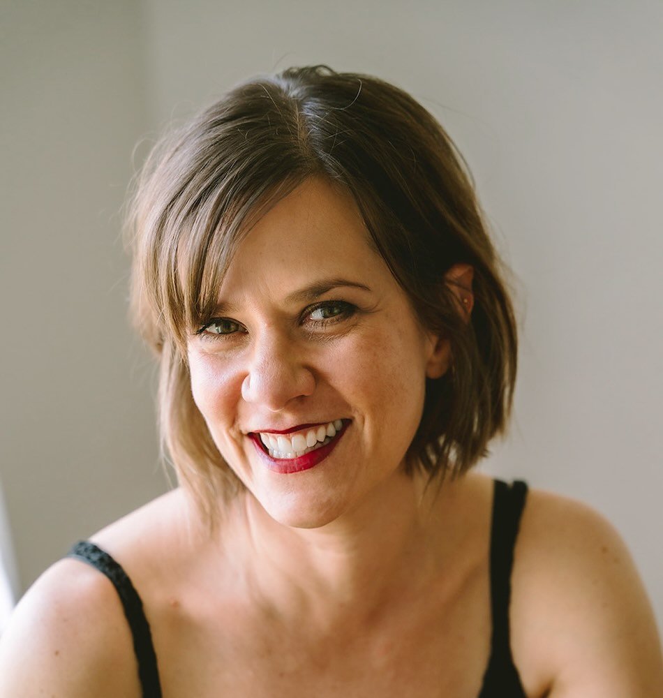 Headshot of a therapist, smiling at the camera.