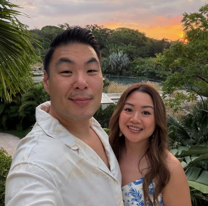 A couple taking a selfie during sunset at the W Punta de Mita hotel in Mexico.