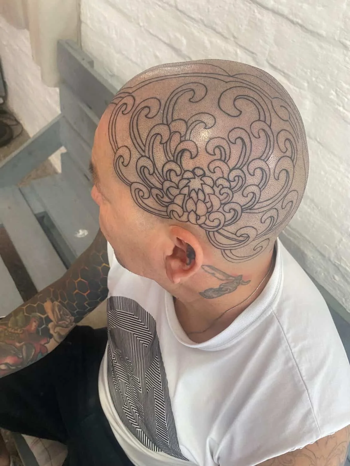 Martin Padilla flower head tattoo