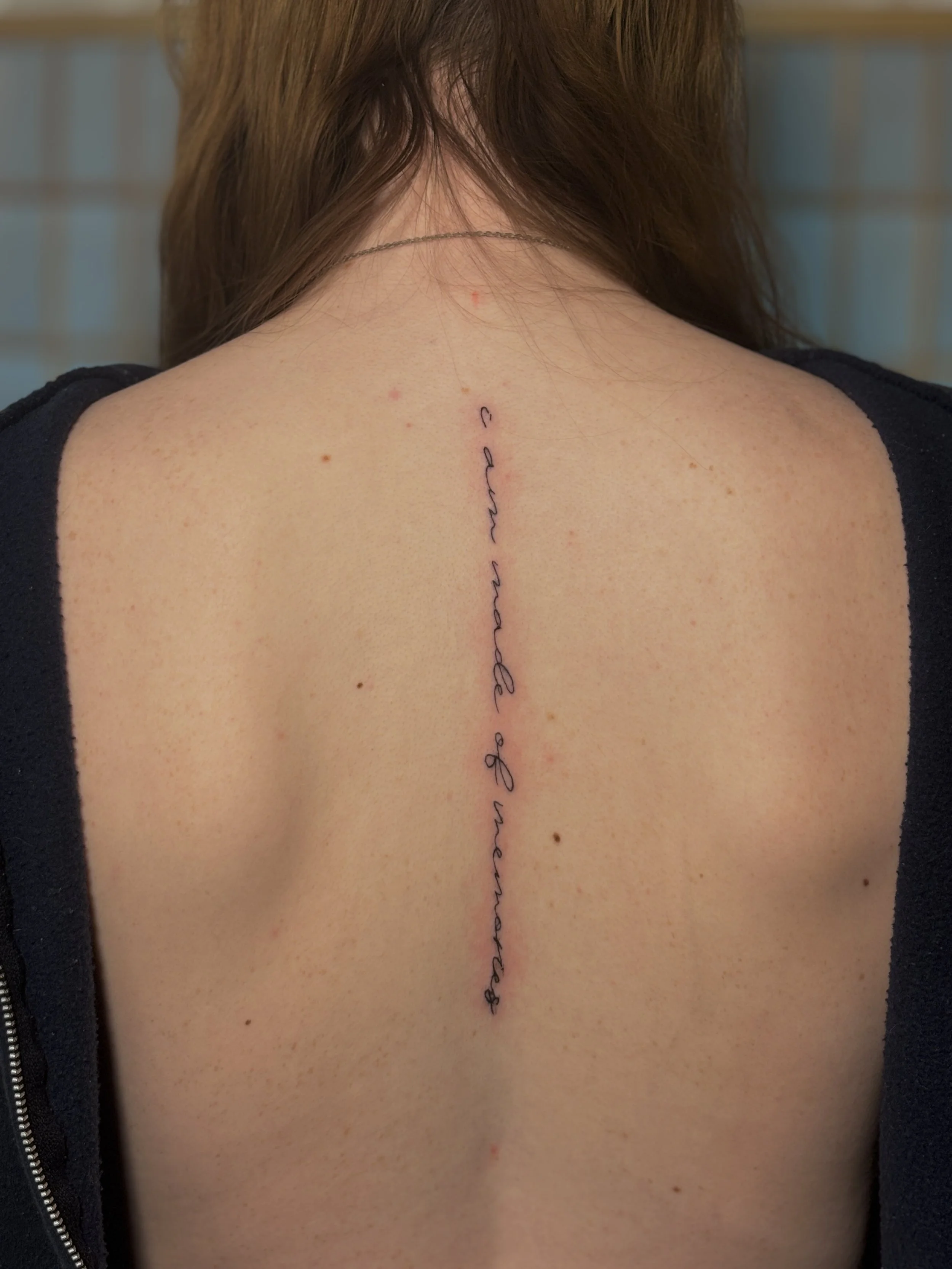 spine writing tattoo