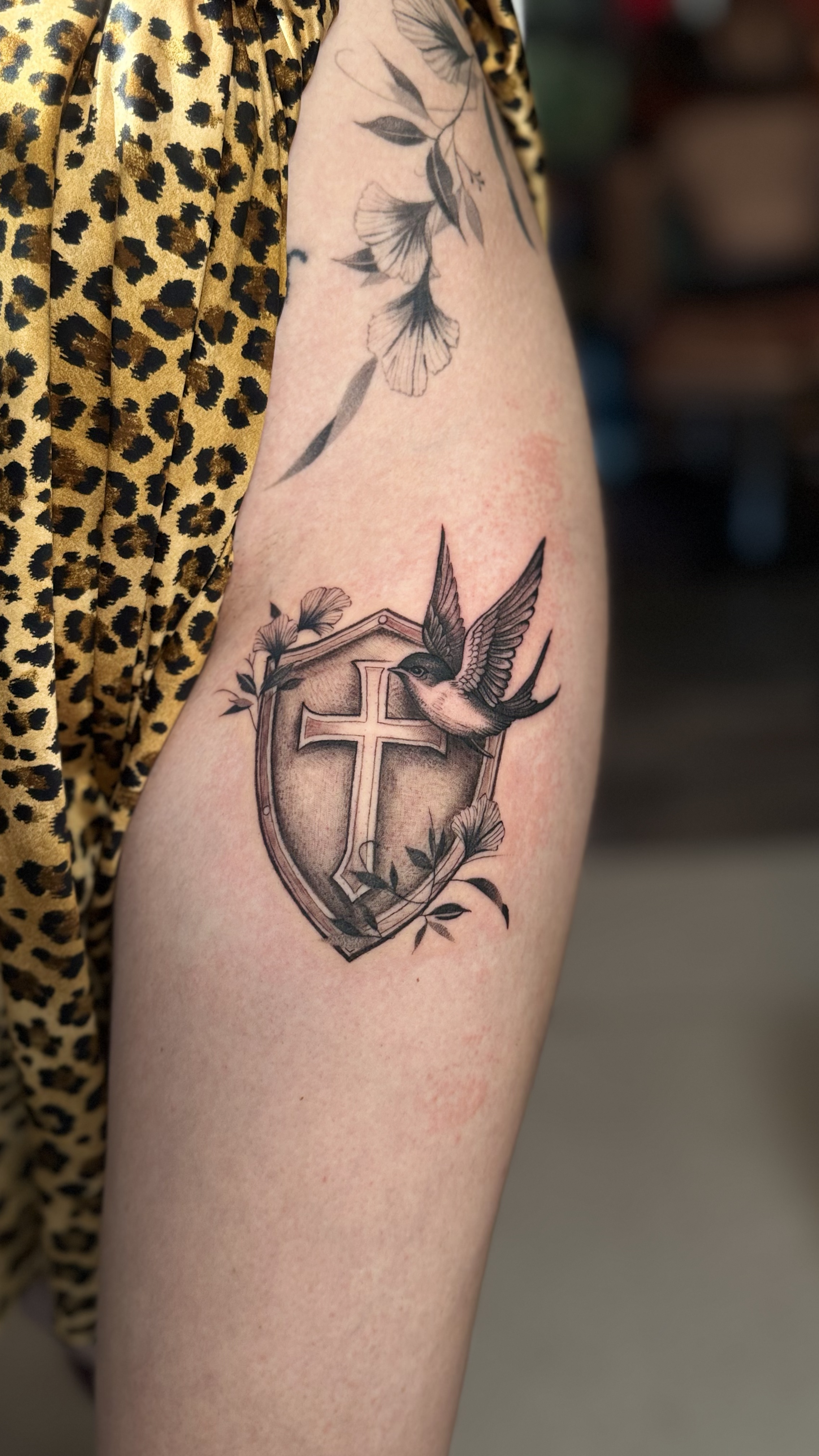 Shield and sparrow tattoo