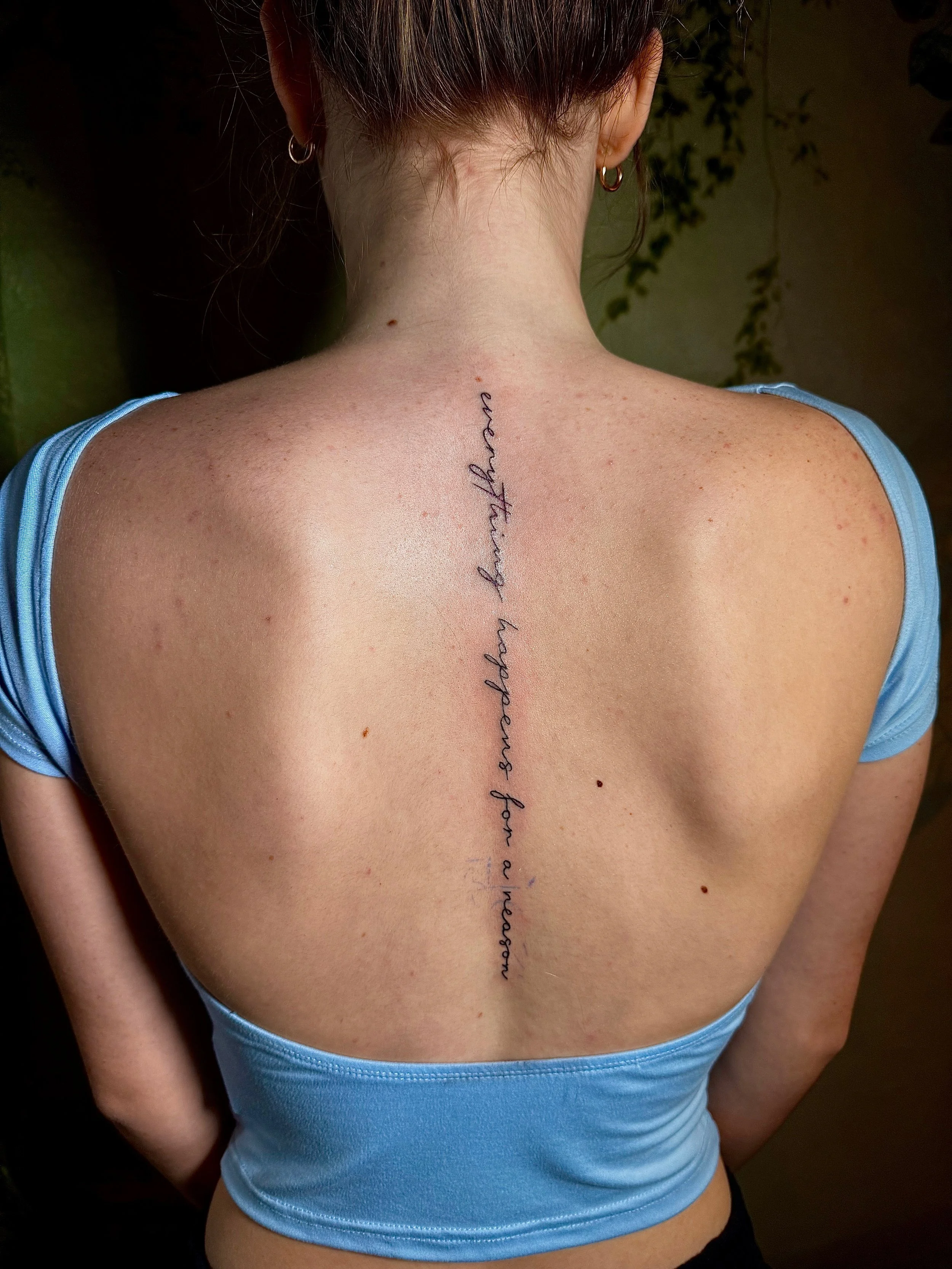 spine writing tattoo