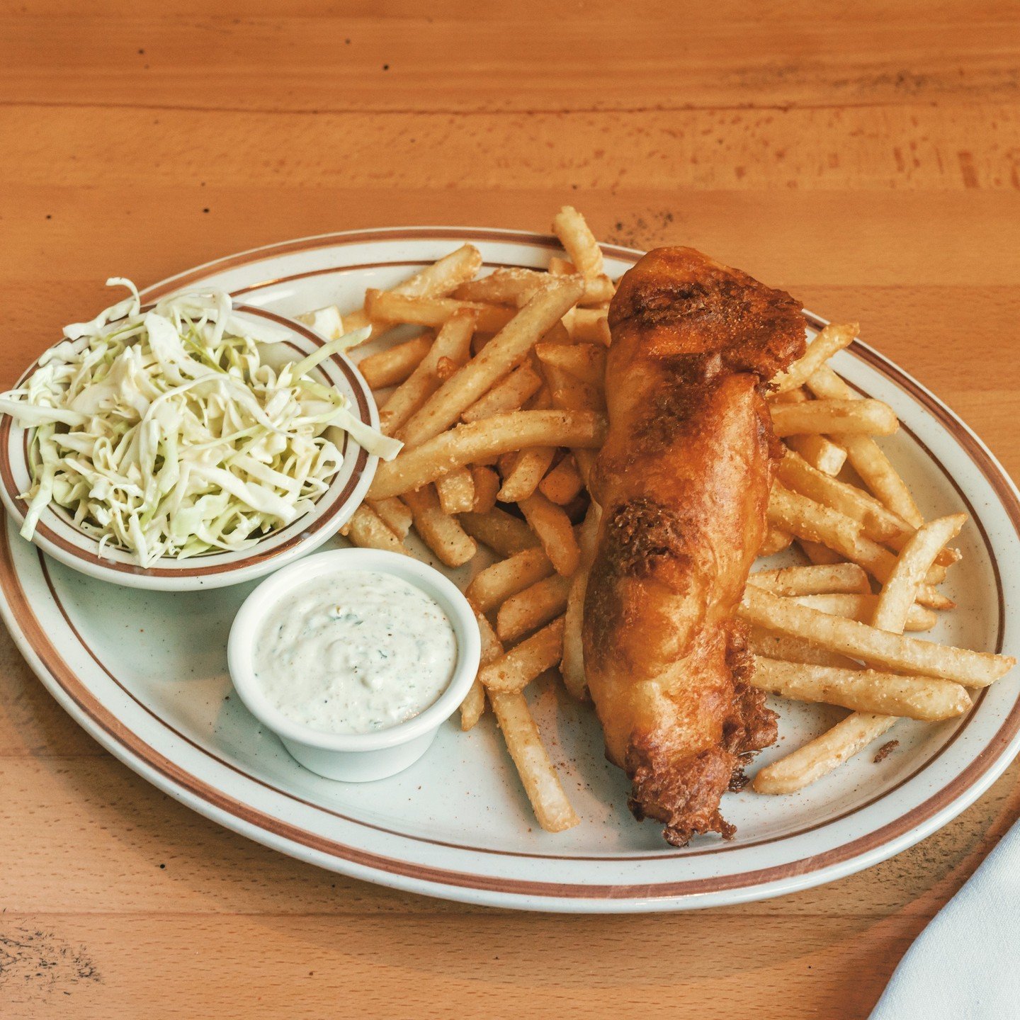 Few dishes say &quot;Pub Classic&quot; quite like Fish and Chips. At The Halfway Club, Chef Jason dips fresh Atlantic Cod in beer batter and fries to a beautiful golden brown and serves it with a house slaw and remoulade. But in a unique twist, the f
