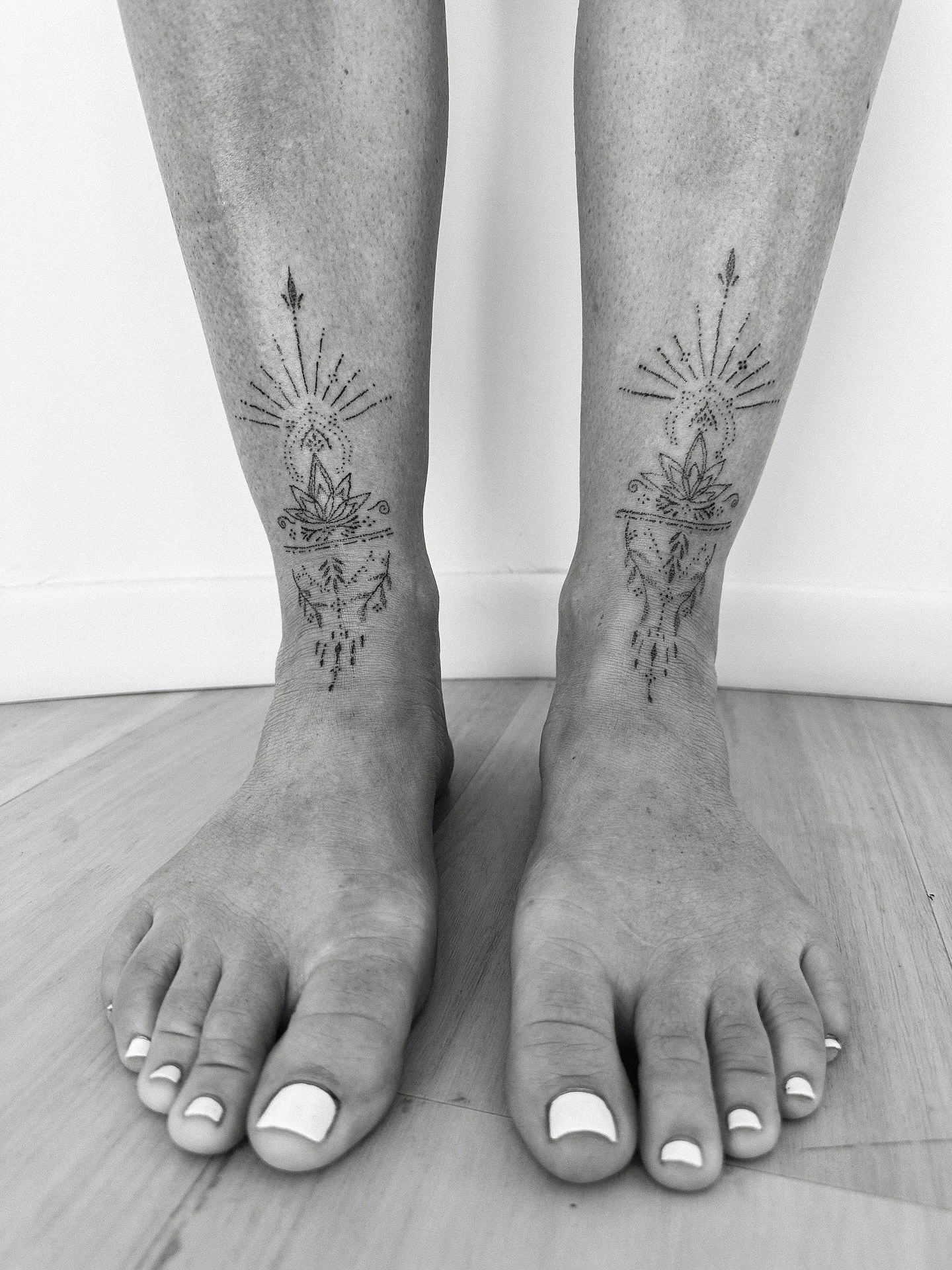 Tattoos etched across the front of the ankles and flowing onto the tops of the feet hold the energy of thresholds. The meeting place between body and earth, where each step becomes a prayer to the path ahead. 

Mirrored on both sides, they weave bala