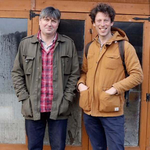 A photograph of Sam Lee and Simon Armitage standing outside a shed