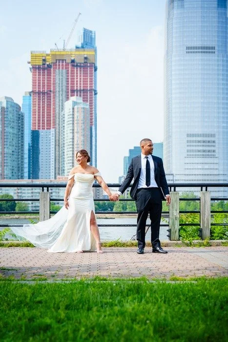 Couple holding hands at Liberty State Park waterfront wedding