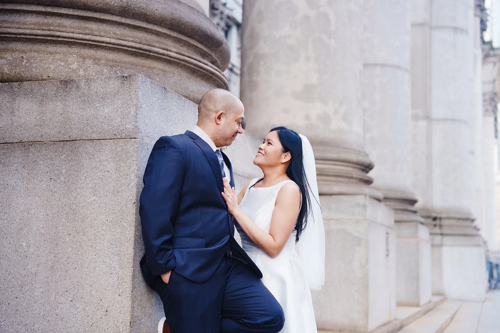 couple taking photos outside NYC City Hall