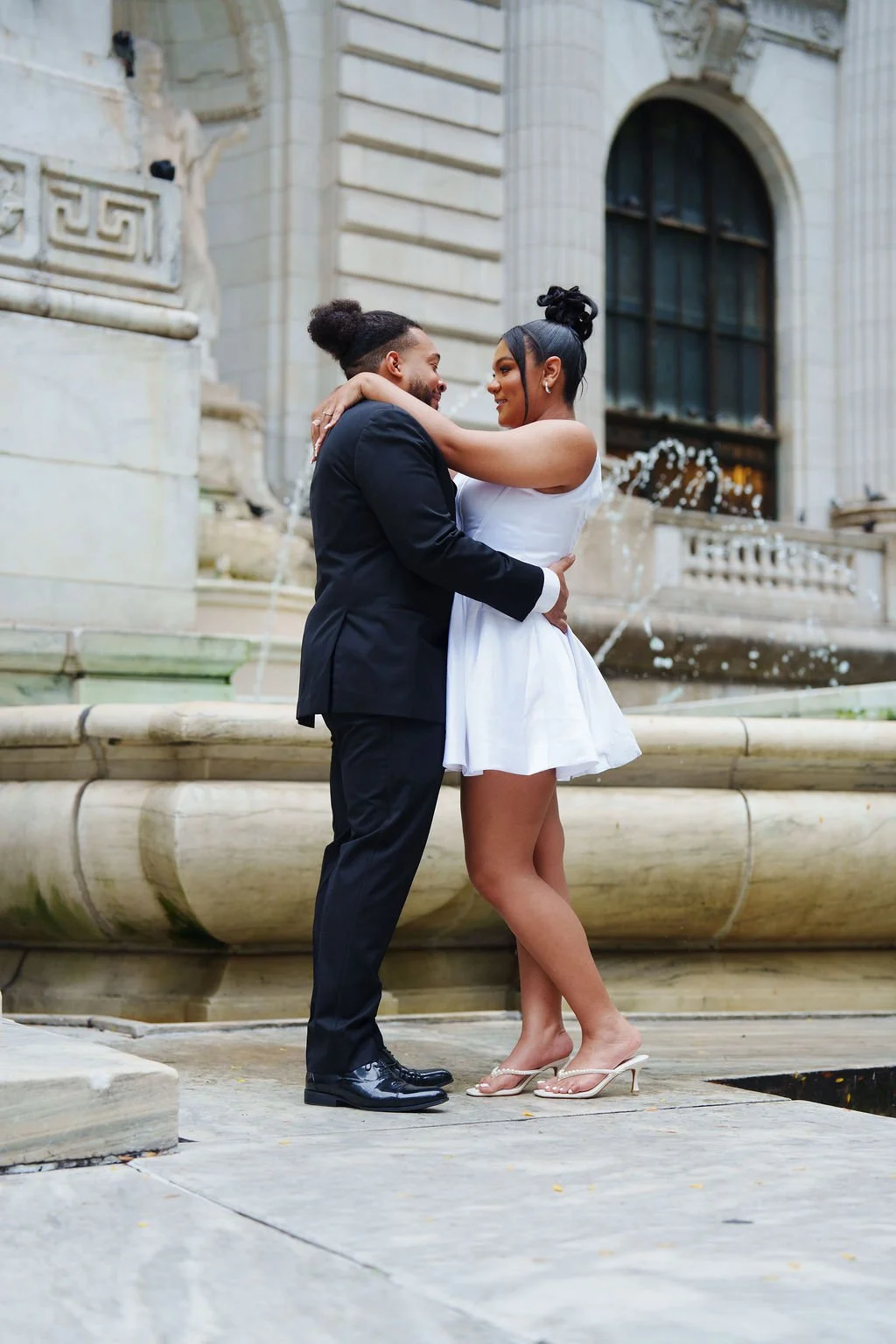 couple posing at new york public library after new york city hall wedding