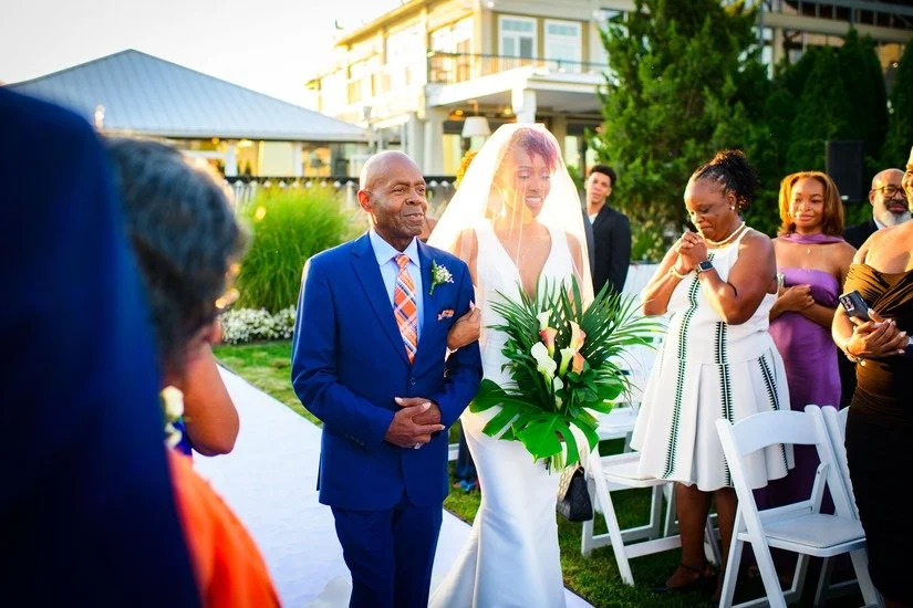 Bride walking down aisle during Liberty State Park outdoor wedding ceremony