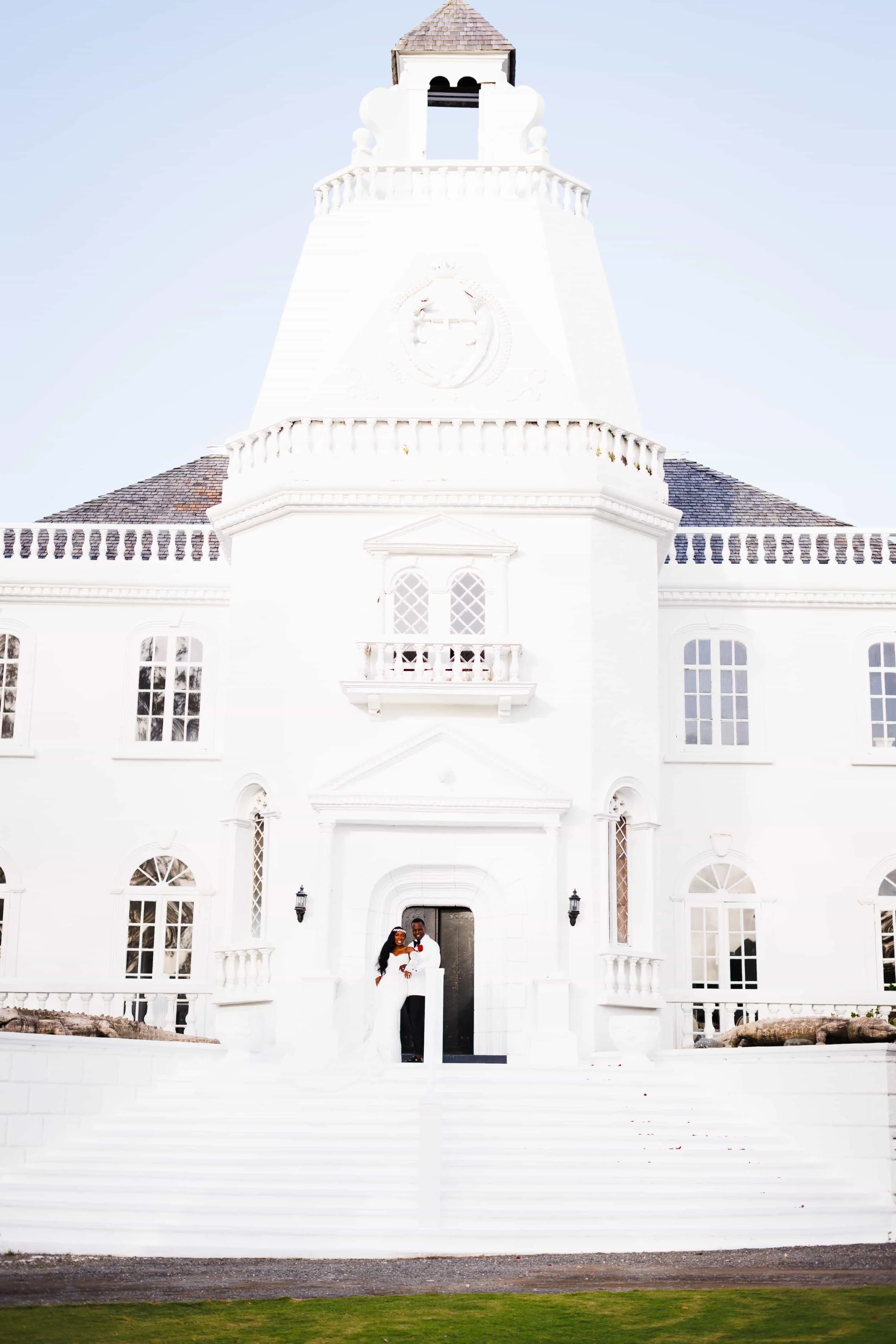 Trident Castle wedding couple standing in front of iconic white castle facade in Jamaica