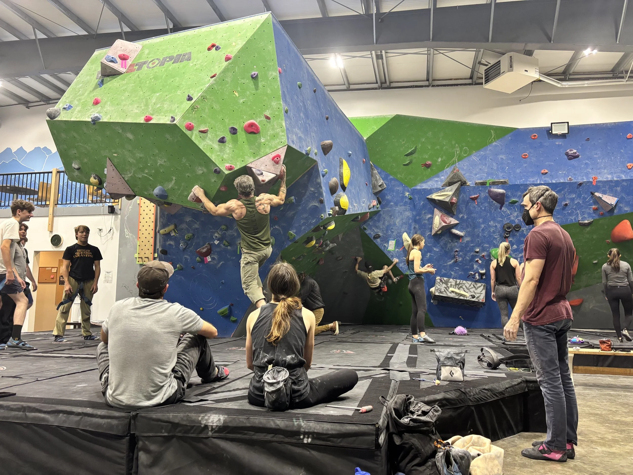 group watching a climber on the nose 