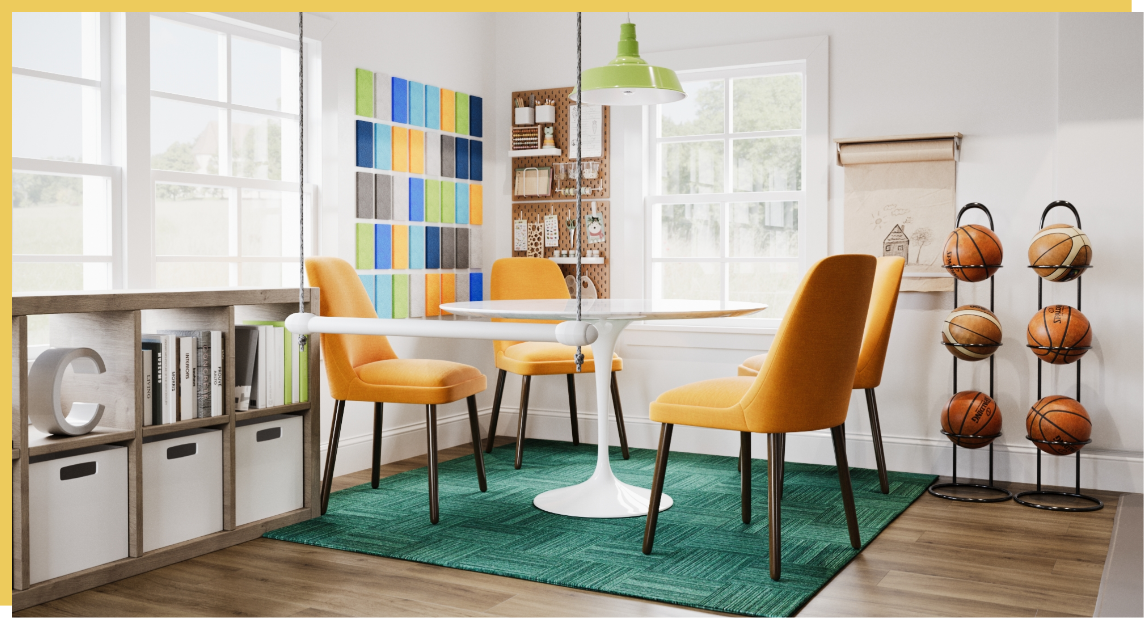 Bright dining room with four yellow chairs around a white round table on a green rug. Large windows, colorful fabric samples on the wall, and a wooden shelf with storage bins. To the right, a display of basketballs, and a corkboard with drawings and supplies, with a large window providing natural light.