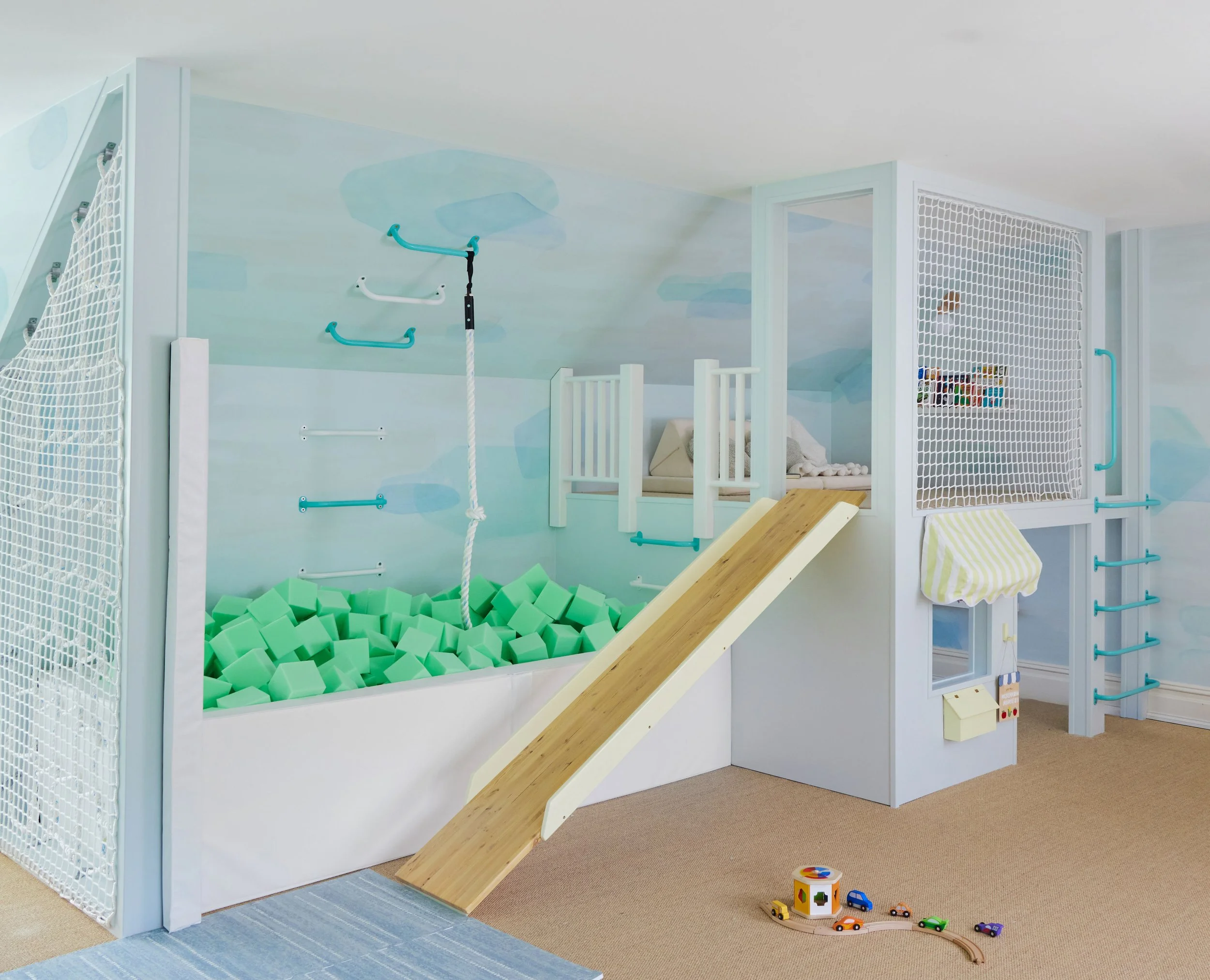 Foam pit and kids' play fort with slide and shop window