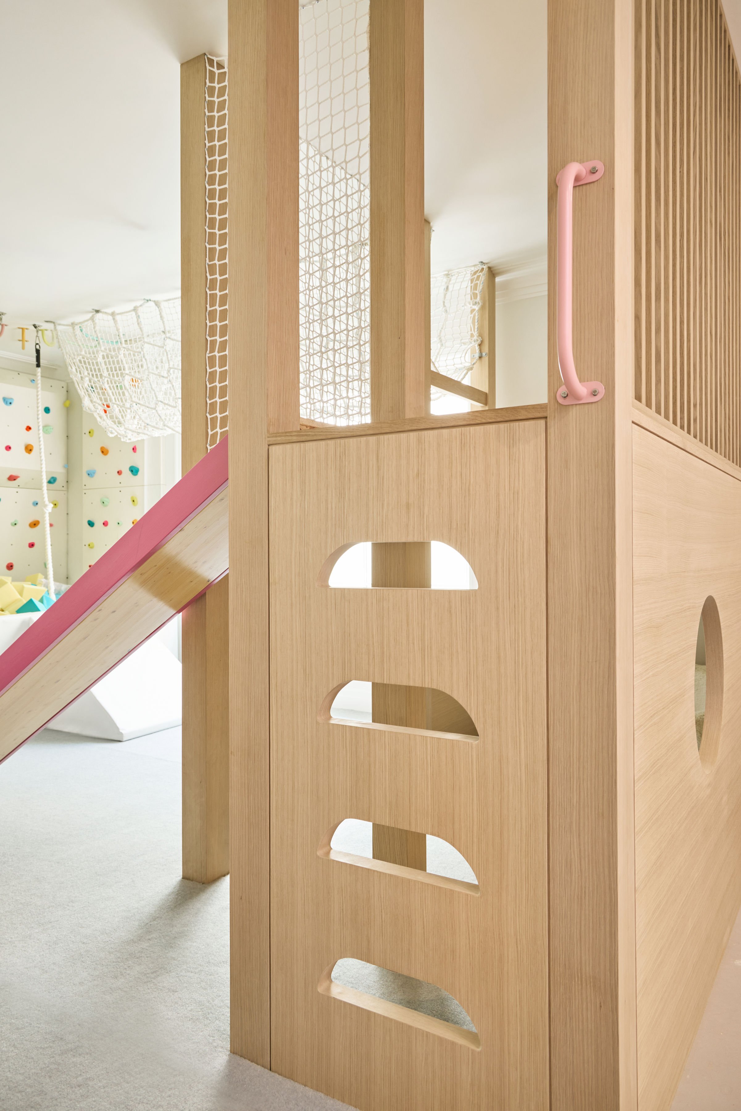 Built-in ladder leading to the upper level of a custom white oak kids' play fort