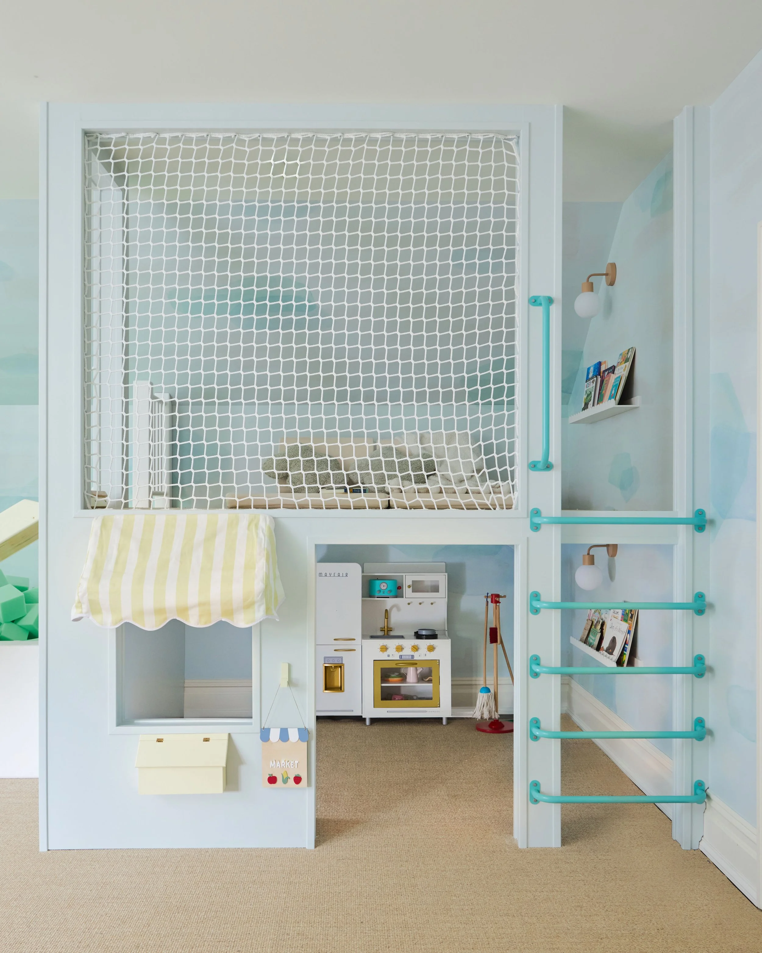 Imaginative play kids' fort with store front and play kitchen downstairs and ladder to the upper level which has safety netting