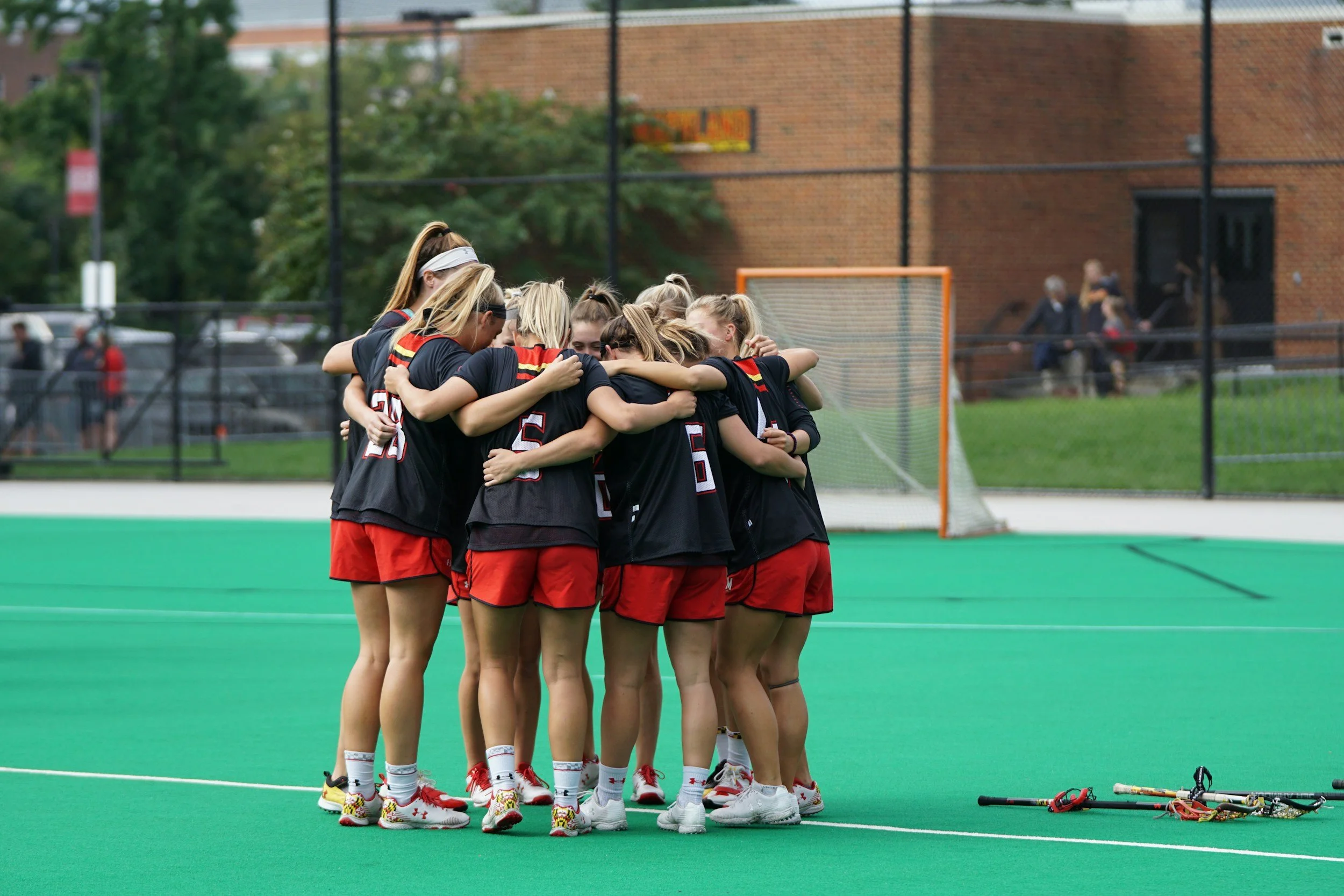 group of female athletes in a huddle
