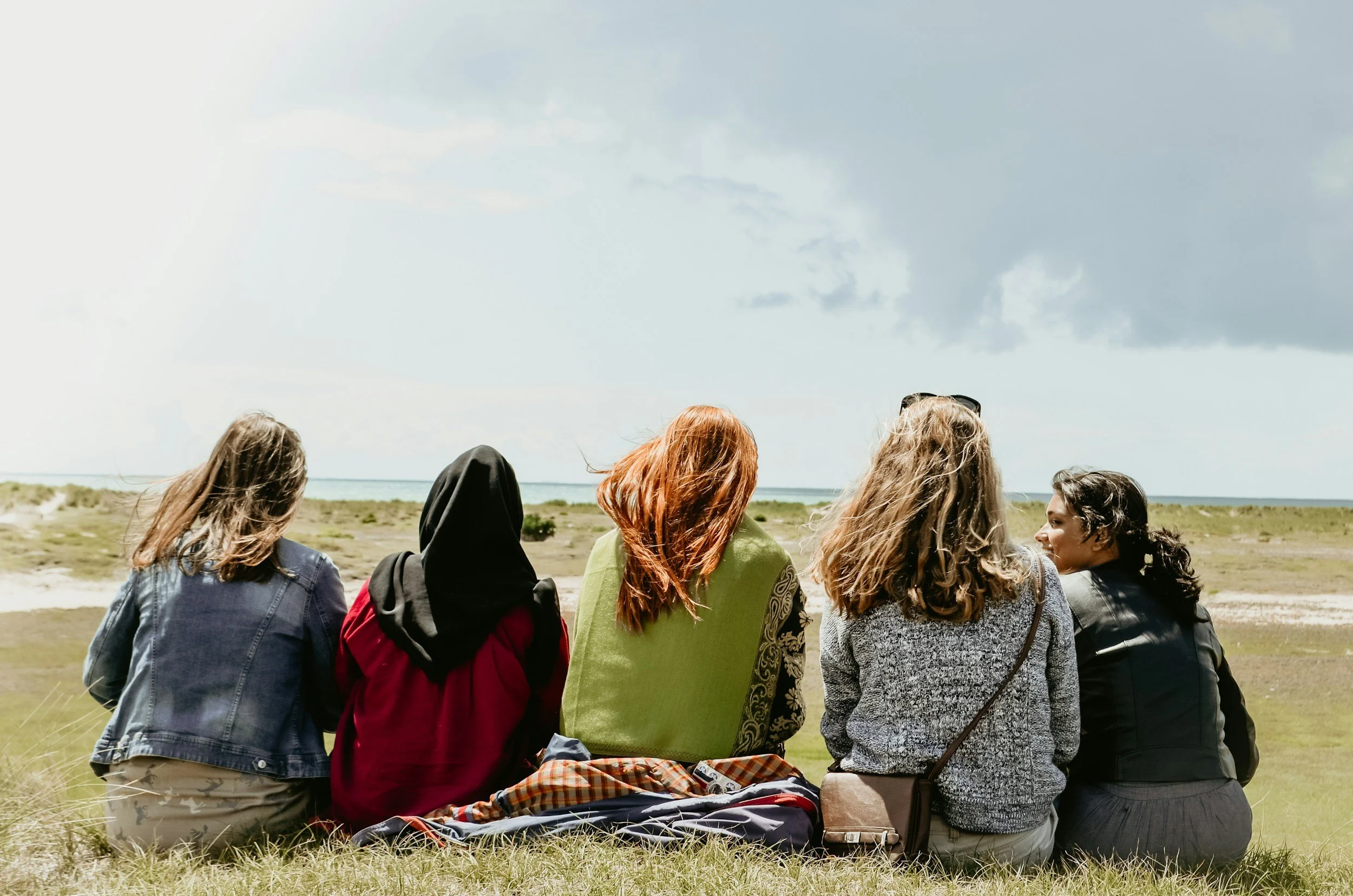 Group of women sitting on grass