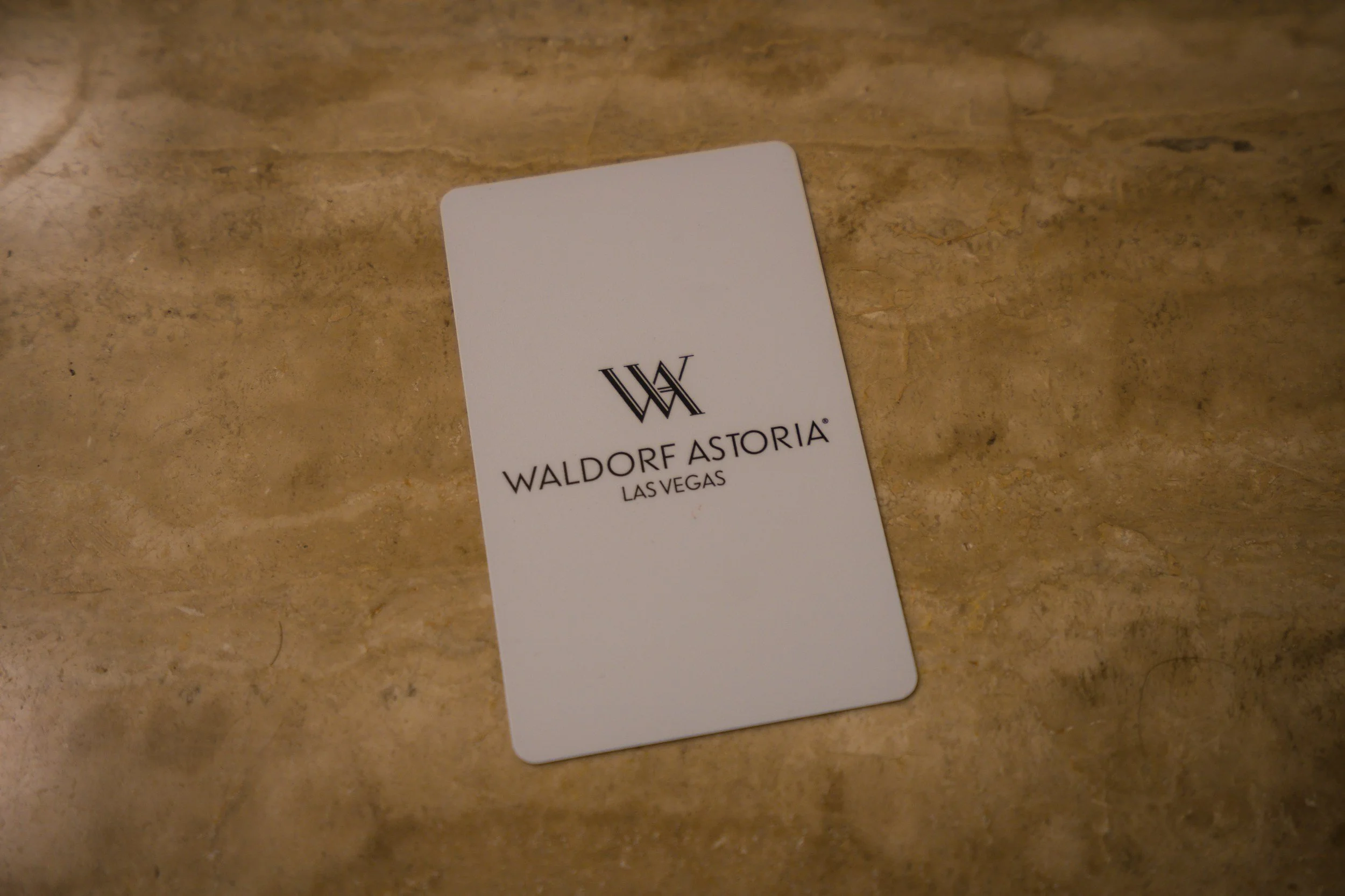 Hotel key card and loyalty program card on marble check-in counter