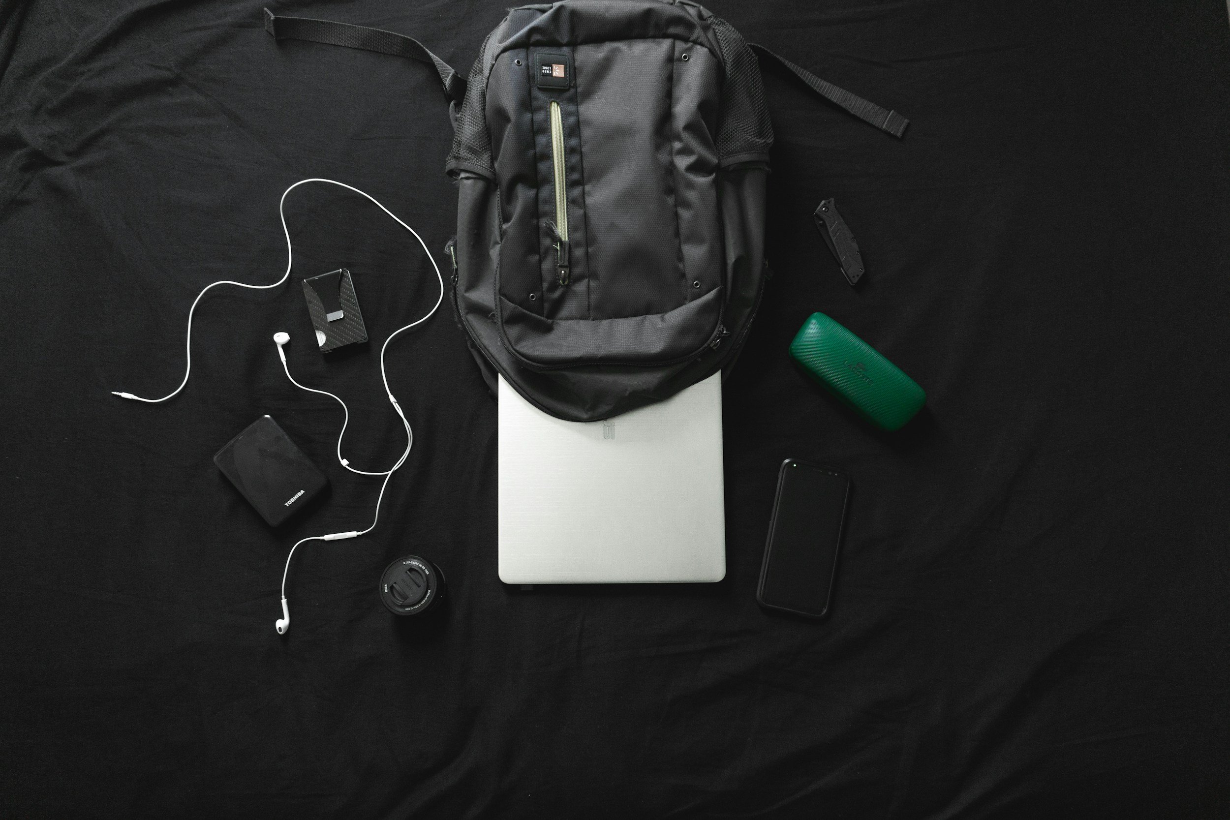 Packed travel bag with laptop, adapter, and professional-casual clothing