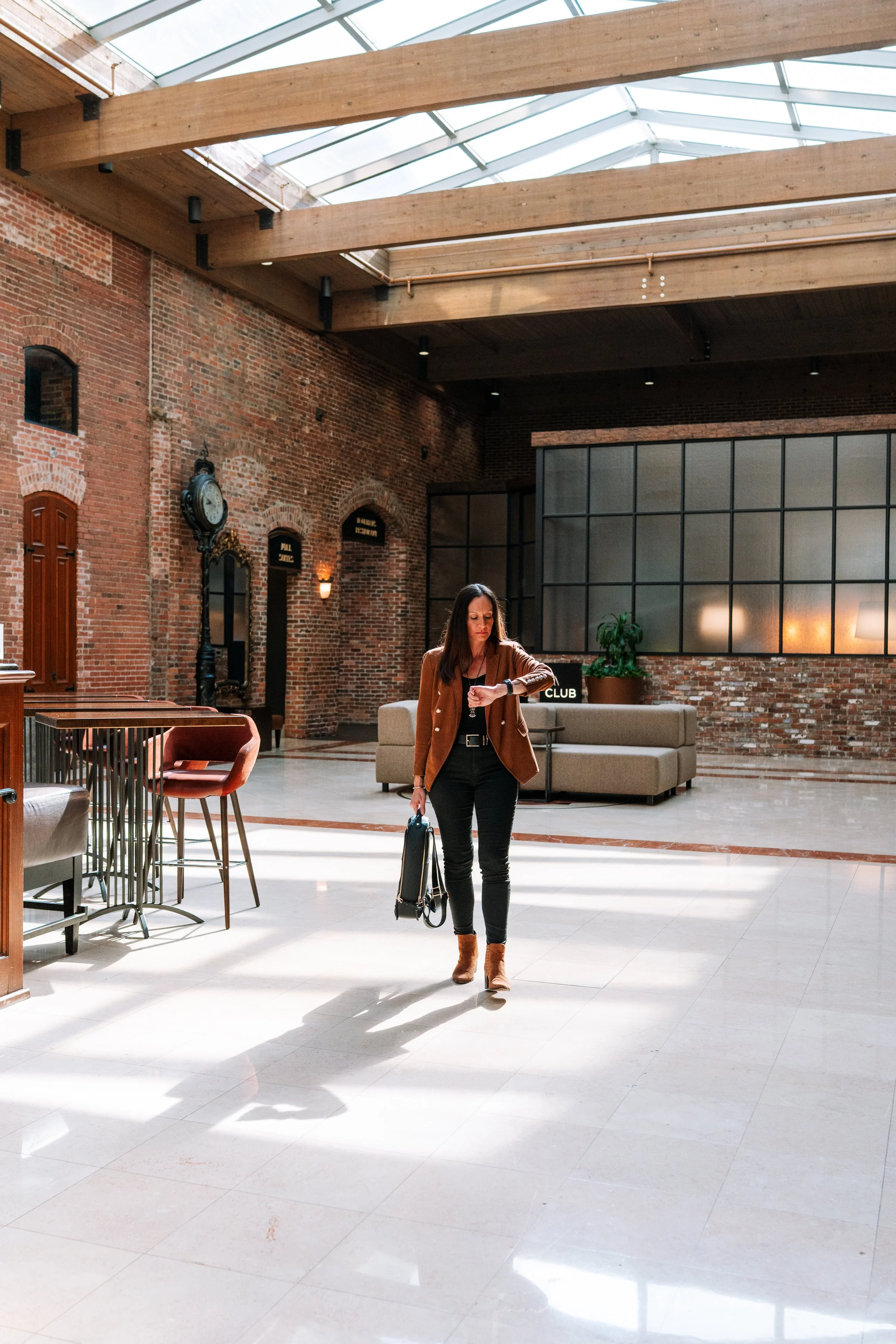 Business traveler in hotel lobby transitioning from meeting to personal time