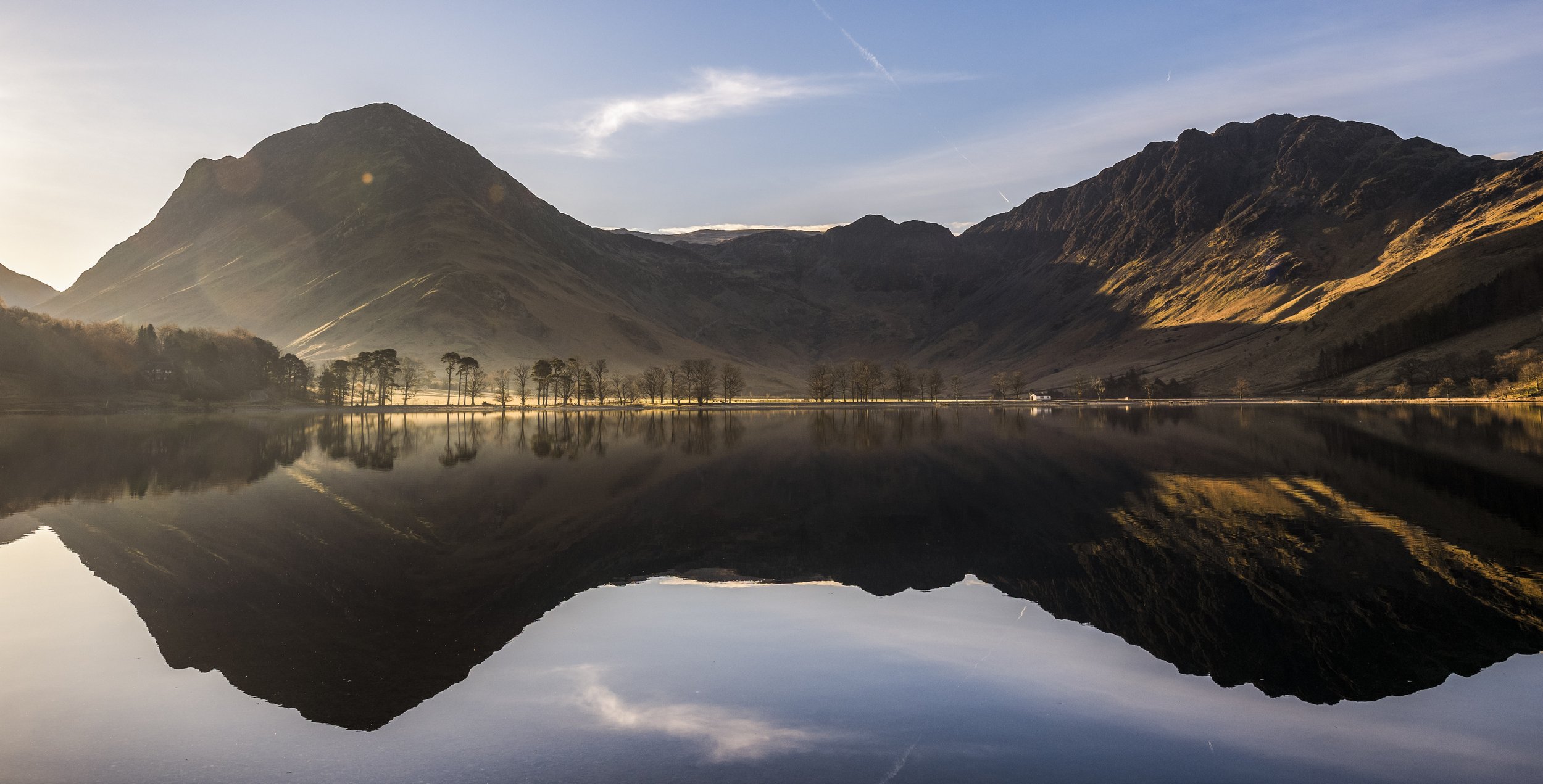 Buttermere Panorama - A wide panoramic view of the Scots pines on Buttermere at sunrise, with Fleetwith Pike and Haystacks behind.