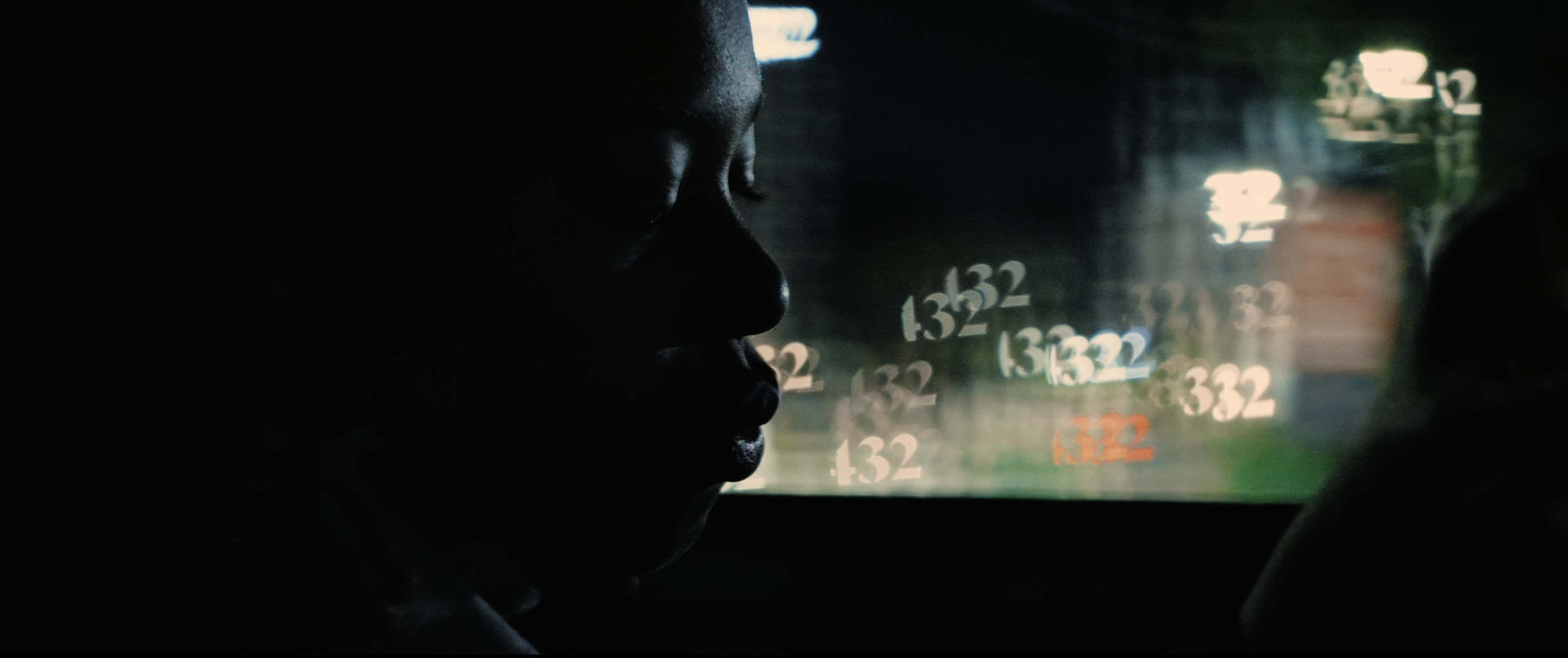 Kodie Shane in back of a car with "432" lens bokeh in the background