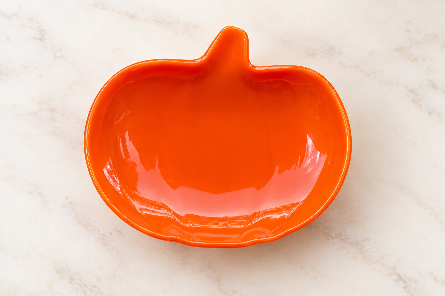 Orange glass pumpkin dish styled with seasonal autumn decorations