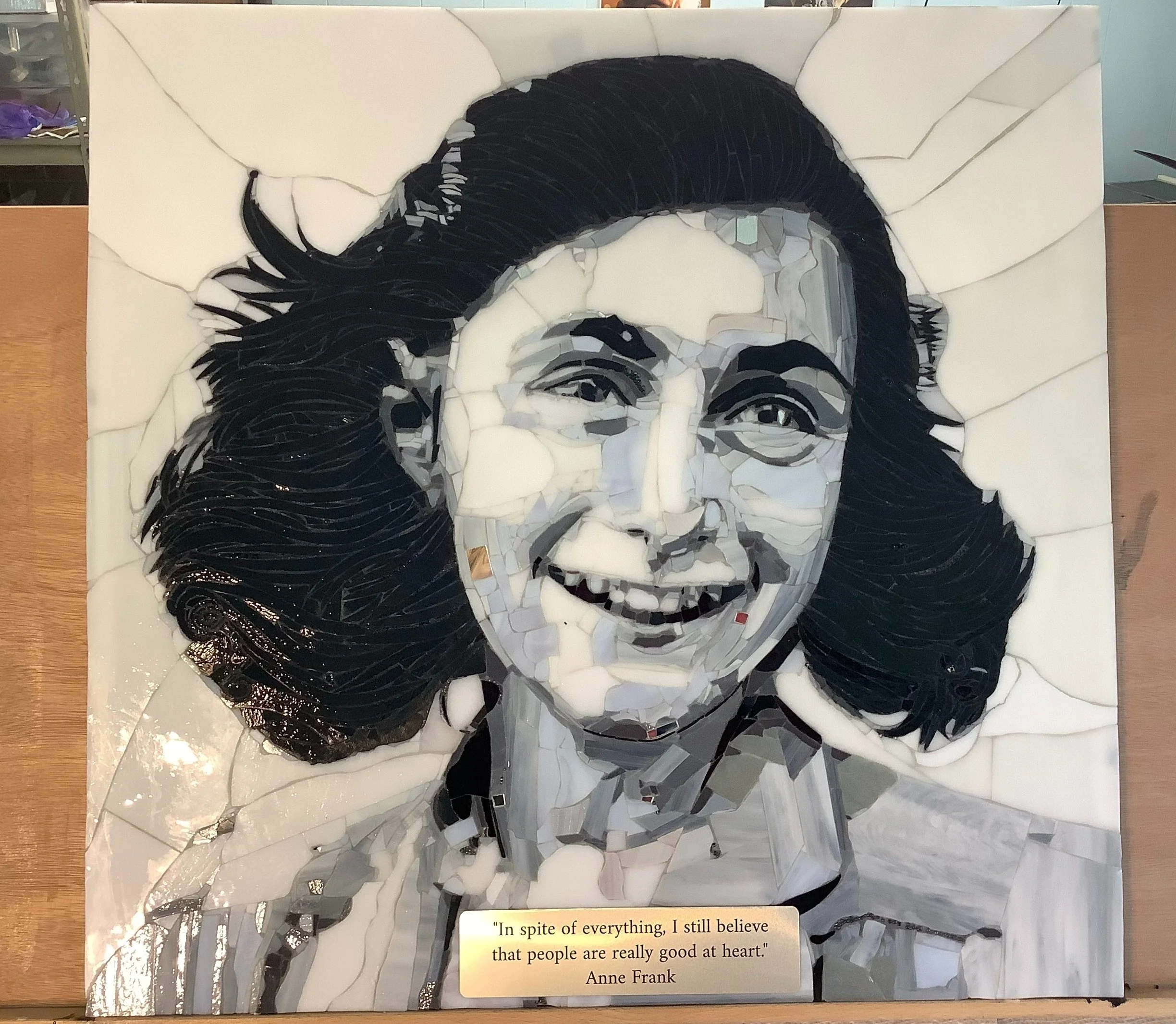 Mosaic artwork of Anne Frank with a quote: 'In spite of everything, I still believe that people are really good at heart.'