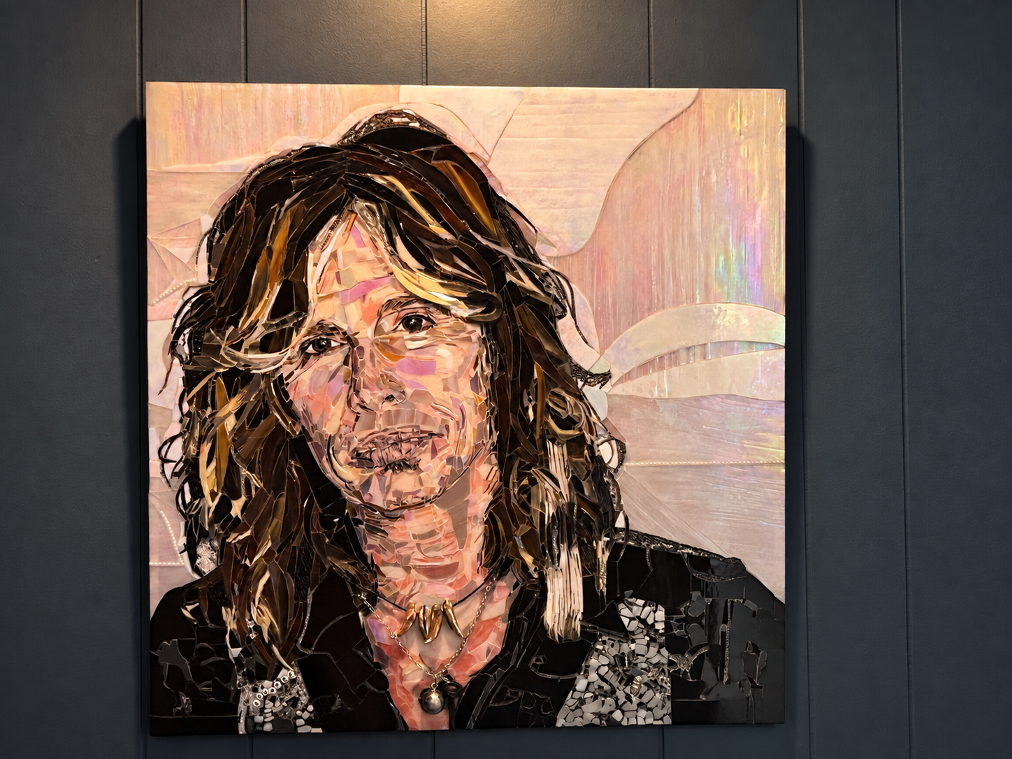 Handmade fused glass portrait of Steven Tyler featuring detailed multicolor glass artwork and an iridescent background by Isola Artistry