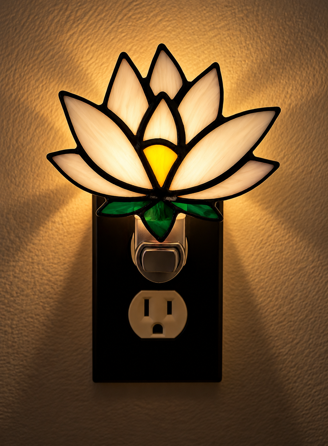 White lotus stained glass night light glowing with warm light against a neutral wall