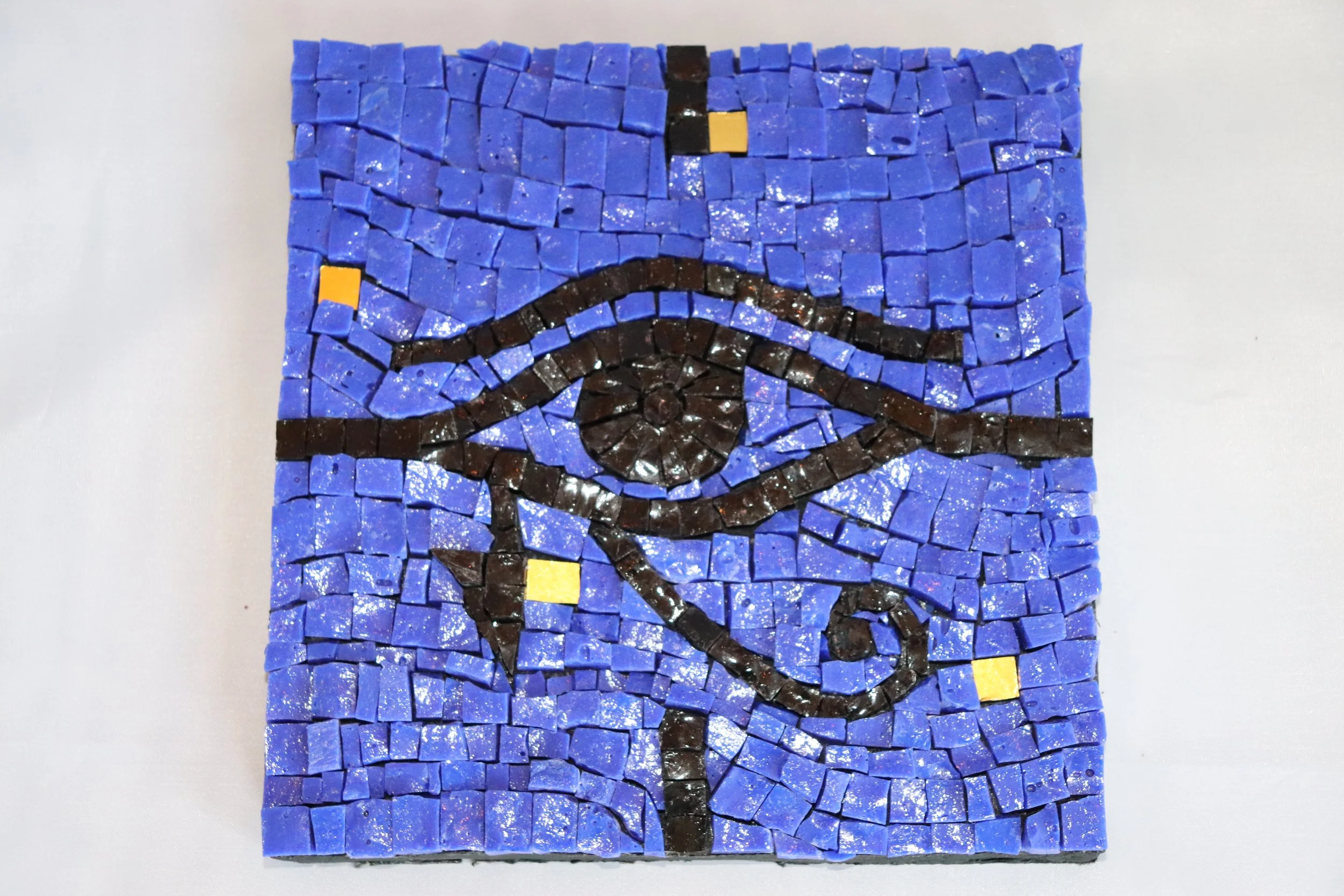 Mosaic artwork of the Mona Lisa created with small square tiles in colors including blue, black, and yellow.