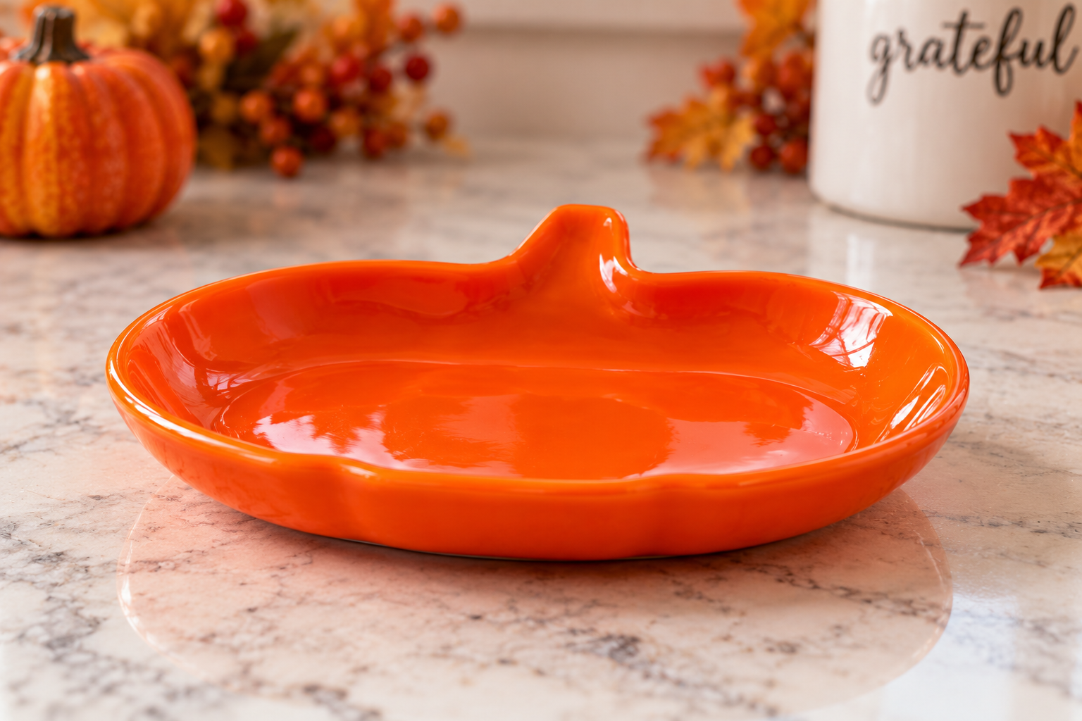 Orange fused glass pumpkin trinket dish showing its handcrafted shape