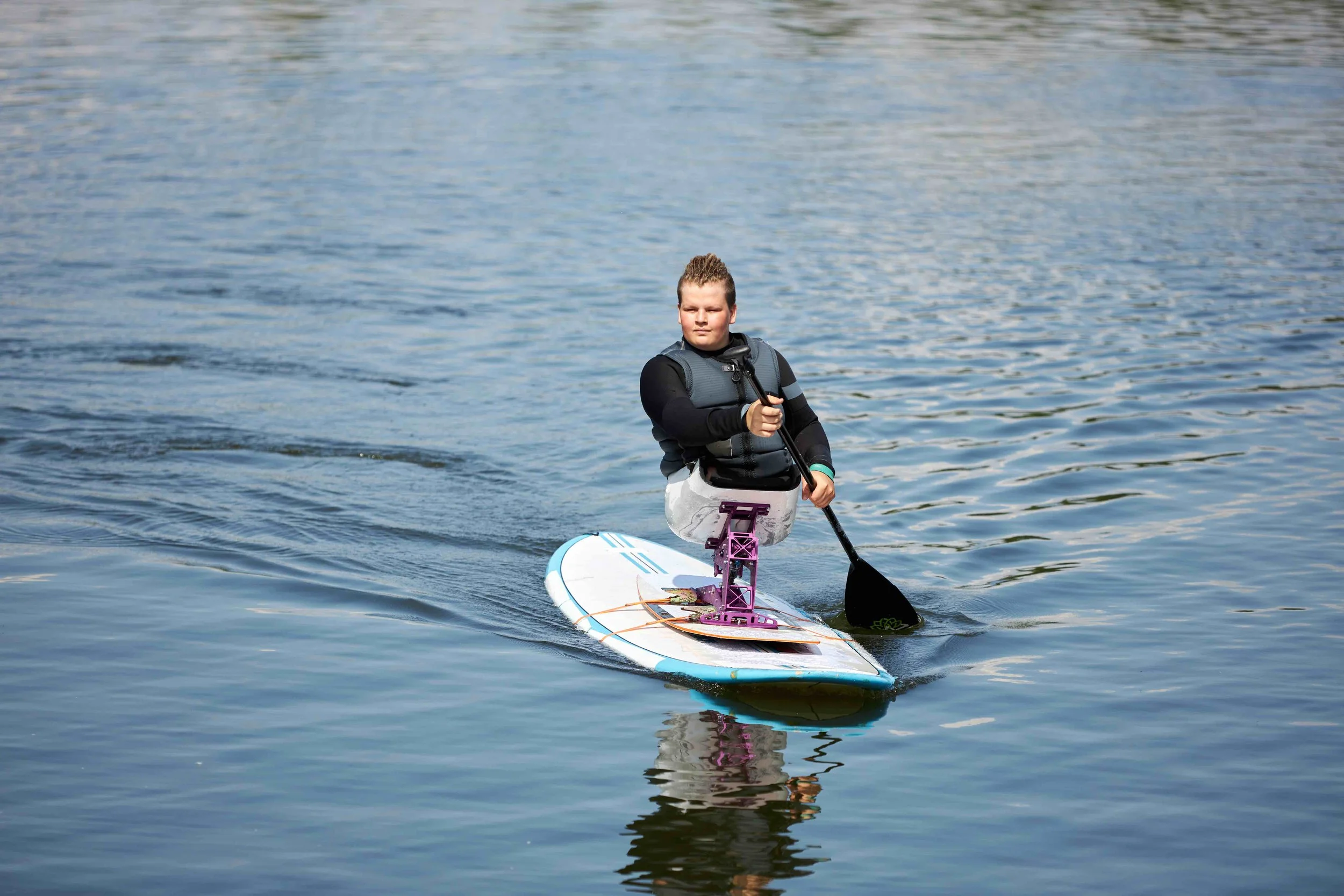 boy-with-disability-paddle-boarding-on-water-with-2023-08-31-04-21-32-utc.jpg